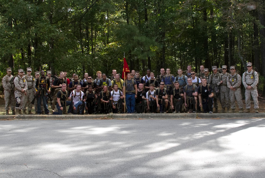 Marines and candidates with Officer Selection Office Raleigh, Marine Corps Recruiting Station Raleigh, pose for a photo following a three-mile hike aboard Umstead Park in Raleigh, N.C., Sept. 28, 2013. The candidates and Marines carried packs with 40 pounds of gear and an M-16 replica rubber rifle to get a feel for hiking while carrying weight.  (U.S. Marine Corps photo by Sgt. Dwight A. Henderson/Released)