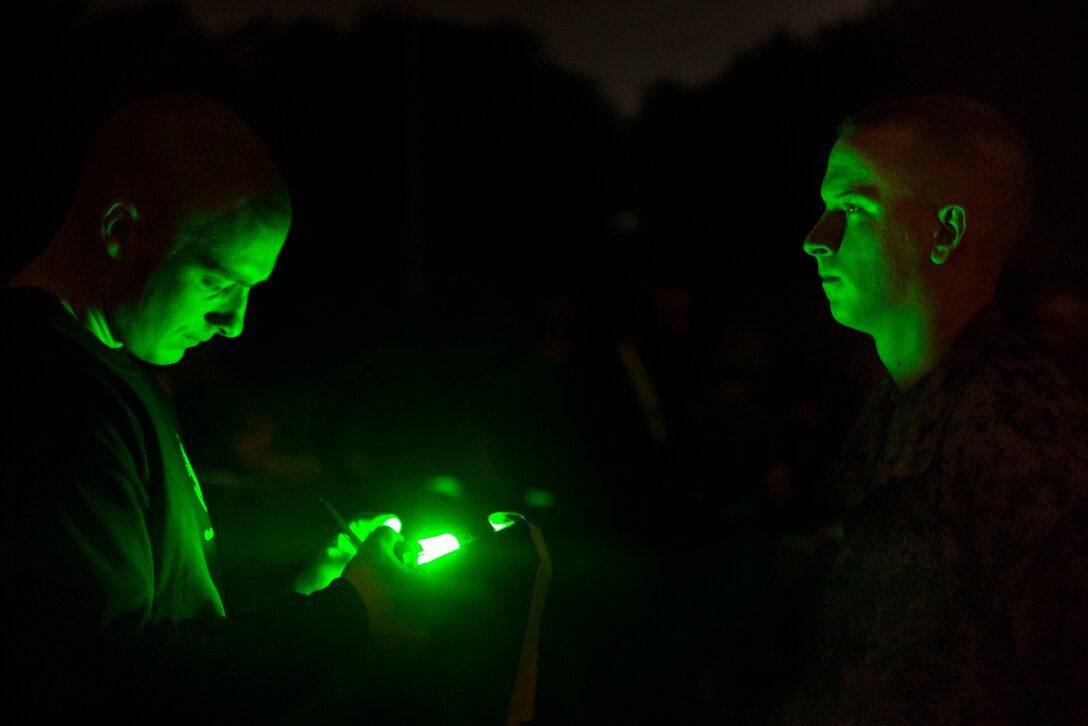 A student at the Infantry Training Battalion records his time with an instructor after completing the movement to contact portion of the Combat Fitness Test at Camp Geiger, N.C., Sept. 26, 2013. The students must pass the ITB standards for the physical fitness test and the CFT to continue on in the course. The students are part of the first ITB company to include female Marines as part of ongoing research into opening combat-related job fields to women. (U.S. Marine Corps photo by Sgt. Tyler L. Main/Released)