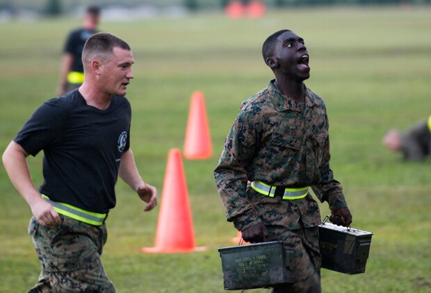 A student with Infantry Training Battalion runs with ammo cans during the Combat Fitness Test at Camp Geiger, N.C., Sept. 26, 2013. The students, regardless of gender, must pass the same ITB standard for the physical fitness test and CFT to continue in the course. The students are part of the first ITB company to include female Marines as part of ongoing research into opening combat-related job fields to women. This photograph has been digitally altered to remove the student's nametape.
(U.S. Marine Corps photo by Sgt. Tyler L. Main/Released)