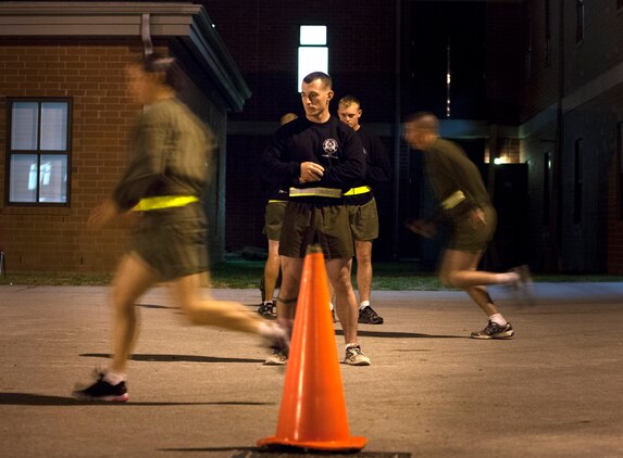A combat instructor at the Infantry Training Battalion times a female student as she completes short sprints as part of the High Intensity Tactical Training assessment aboard Marine Corps Base Camp Geiger, N.C., Sept. 27, 2013. Fifteen female Marines were given the opportunity to attend the training after boot camp for the first time in Marine Corps history as part of ongoing research into the acceptance of women into combat-related job fields. The female Marines go through the same training and are held to the same ITB standards as their male counterparts. (U.S. Marine Corps photo by Cpl. Chelsea Flowers Anderson/Released)