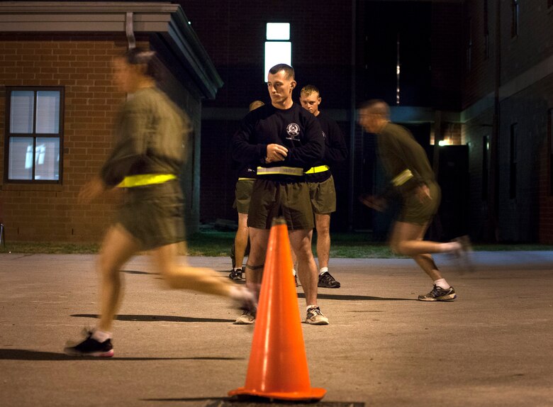 A combat instructor at the Infantry Training Battalion times a female student as she completes short sprints as part of the High Intensity Tactical Training assessment aboard Marine Corps Base Camp Geiger, N.C., Sept. 27, 2013. Fifteen female Marines were given the opportunity to attend the training after boot camp for the first time in Marine Corps history as part of ongoing research into the acceptance of women into combat-related job fields. The female Marines go through the same training and are held to the same ITB standards as their male counterparts. (U.S. Marine Corps photo by Cpl. Chelsea Flowers Anderson/Released)