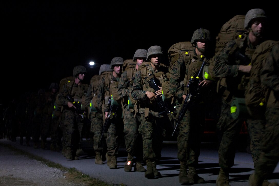 Students at the Infantry Training Battalion carry packs on a 5-kilometer hike during their first week of training at Marine Corps Base Camp Geiger, N.C., Sept. 28, 2013. The students will complete 10-kilometer, 15-kilometer and 20-kilometer hikes throughout their training iteration. Fifteen female Marines were given the opportunity to attend the training after boot camp for the first time in Marine Corps history as part of ongoing research into the acceptance of women into combat-related job fields. The female Marines go through the same training and are held to the same ITB standards as their male counterparts. (U.S. Marine Corps photo by Cpl. Chelsea Flowers Anderson/Released)