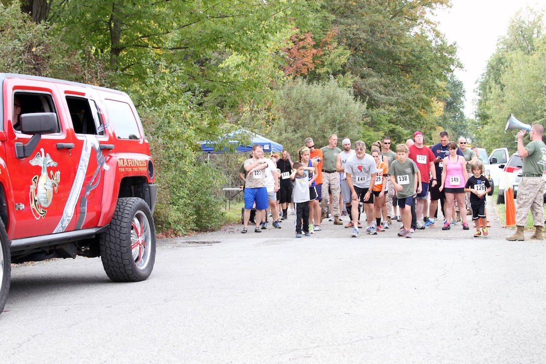 Runners at the starting line await the signal to begin the 3rd Annual Toys for Tots 5K run at Imagination Station Park in Cortland, Ohio, Sept. 29, 2013. The event, hosted by the Marines of Detachment 3 Maintenance Company, Combat Logistics Battalion 453, is their official kick-off for the Toys for Tots donation season, which runs from October through Christmas. The Marines have approximately 300 donation boxes set up locally throughout Trumball and Mahoning Counties in support of the program that has been run by the Marine Corps Reserves since 1947. (U.S. Marine Corps photo by Sgt. T.M. Stewman/Released)