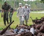 Members of the Guyana Defence Force and the Florida National Guard conduct an armory assessment at a compound housing expended artillery shells and ammunition in Guyana, April 24, 2013.