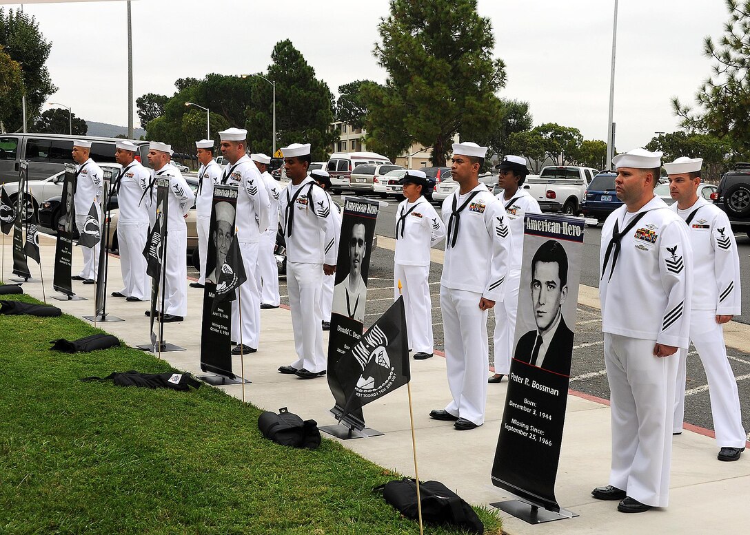 Sailors from the Naval Hospital Camp Pendleton 1st Class Petty Officers Association display the names and portraits of seven Navy hospital corpsmen still missing from the Vietnam War during a service of remembrance at the NHCP Prisoner of War/Missing in Action Memorial on National POW/MIA Recognition Day Sept. 20.   Naval Hospital Camp Pendleton held its 23nd annual Prisoner of War/Missing in Action Remembrance Ceremony on the front lawn of the hospital at the POW/MIA memorial site.   (U.S. Navy photo by Petty Officer 1st Class Michael R. McCormick)