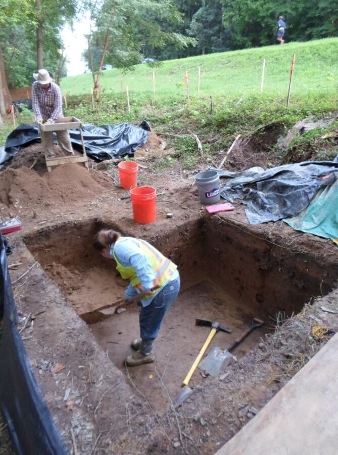 Contractors with the Louis Berger Group work in the area designated “Locus A” near Russell Road on July 31, 2013. Archaeologists found two large fire pits and a high concentration of fire-cracked rocks in the area indicating some unknown but specific use by ancient Native Americans. 