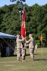 Navy Capt. Cameron Waggoner (left), the outgoing commanding officer of 2nd Medical Battalion, takes the organizational colors from Master Chief Petty Officer Michael Roberts (right), the Command Master Chief for the battalion,  before passing the colors to Navy Capt. Michael Sokolowski (center), the incoming commanding officer, during a change of command ceremony for 2nd Medical Battalion, Combat Logistics Regiment 25, 2nd Marine Logistics Group aboard Camp Lejeune, N.C., Sept. 30, 2013. The passing of the colors symbolized the passing of total responsibility, authority and accountability for the battalion.  (U.S. Marine Corps photo by Lance Cpl. Shawn Valosin)