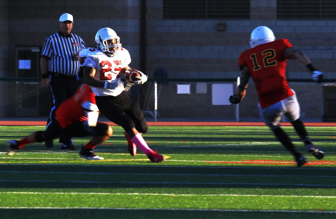 Ryan Marshall jukes right during a Commanding General’s Cup football game at the 11-Area football field Sept. 30. Marshall is a running back for Marine Corps Base Spartans. The Spartans beat the 11th Marines Cannon Cockers 40 to 13.