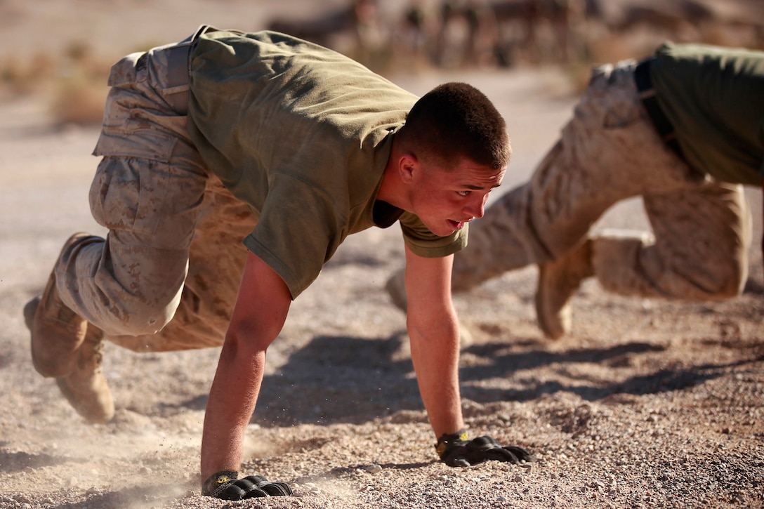 A Marine with Fox Company, 2nd Battalion, 3rd Marine Regiment, does mountain climbers during a physical training time while the unit is conducting the Integrated Training Exercise at the Marine Corps Air Ground Combat Center Twentynine Palms, Calif., Sept. 17, 2013. (U.S. Marine Corps photo by Cpl. Sarah Dietz)