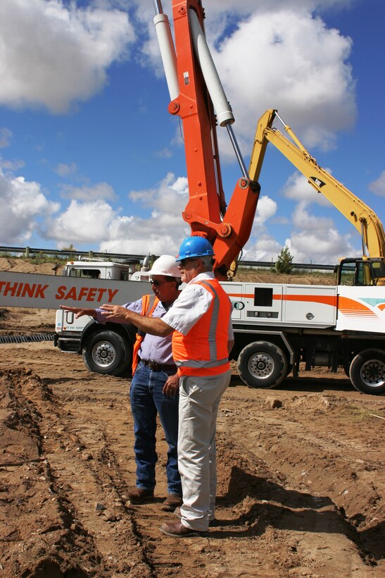 GALISTEO DAM, N.M., -- Victor Chavez and Mike Hamman discuss work being done on the culvert under the dam's access road, Sept. 11, 2013. Chavez is the superintendent of the project and Hamman is the Bureau's area manager.