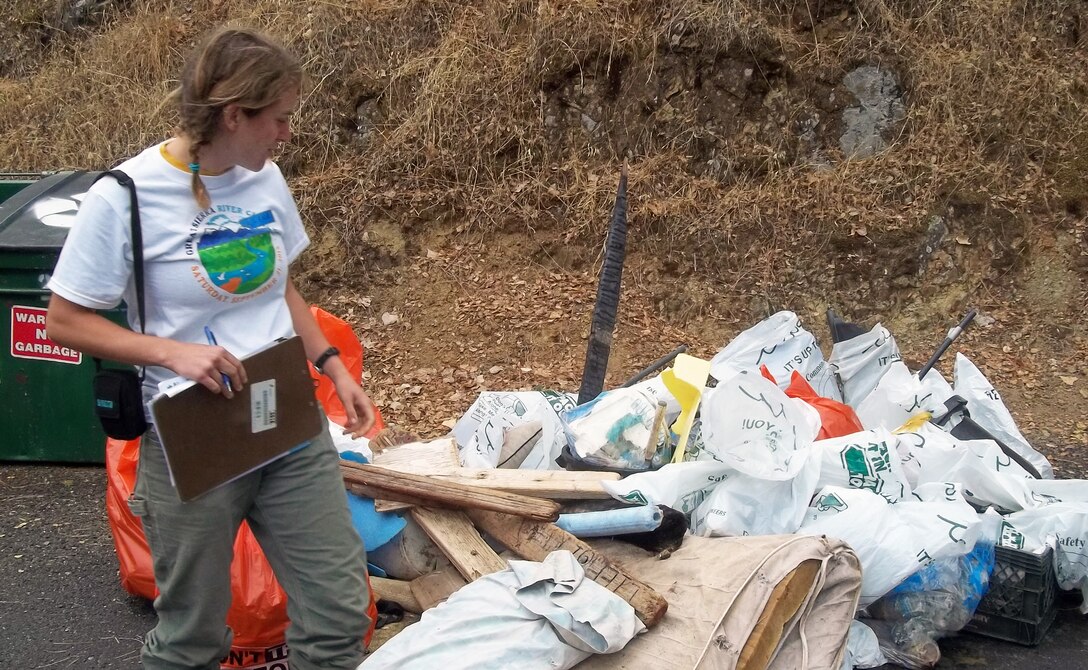 A volunteer with the South Yuba River Citizens League helps in the removal of 450 pounds of trash and 50 pounds of recyclables during the 16th annual Yuba River Cleanup event, Sept. 21, 2013, at Englebright Lake, the U.S. Army Corps of Engineers Sacramento District park near Smartsville, Calif. (U.S. Army photo by Tom Bookholtz/Released)