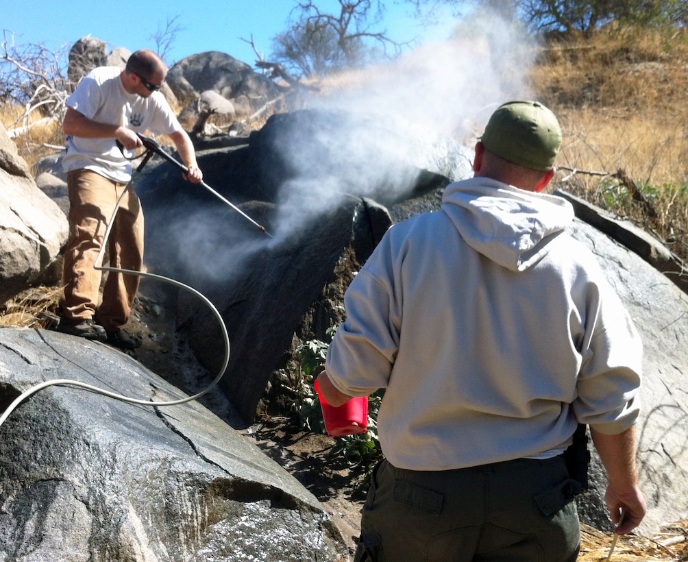 Volunteers work to remove graffiti at Cobble Knoll Recreation Area of Lake Kaweah, the U.S. Army Corps of Engineers Sacramento District park near Lemon Cove, Calif. This was one of several projects accomplished at Lake Kaweah during National Public Lands Day, Sept. 28, 2013. (U.S. Army photo by Bill Spring/Released)