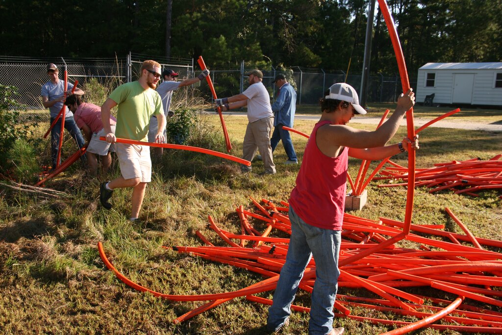 CLARKS HILL, S.C. -- Volunteers from Georgia Southern University build fish attractors using orange piping and cinder blocks on National Public Lands Day, Sept. 28, 2013. The fish attractors will be submerged in the U.S. Army Corps of Engineers J. Strom Thurmond Lake to provide cover for fish and enhance habitat.