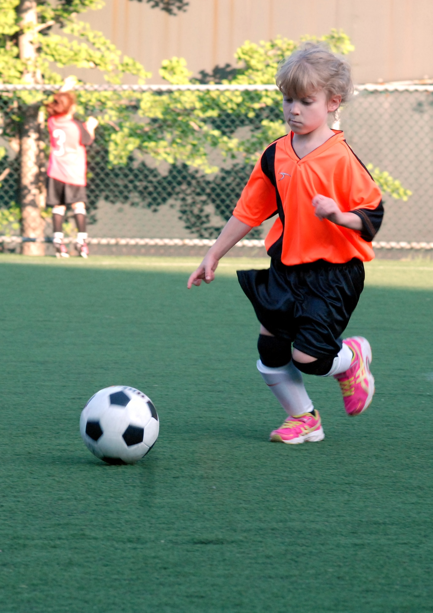 Kaylee Turner, daughter of Master Sgt. John Turner Jr., dribbles the ball during her team’s first youth soccer game at Osan Air Base, Republic of Korea, Sept. 25, 2013. As a member of the Dragons, age 5-6 division, Turner learns basic fundamental skills and rules of soccer during the season. Youth sports are made possible by dedicated volunteer coaches from the base community. If interested in volunteering for seasonal youth sports, contact the director of youth sports by emailing matthew.sharman@us.af.mil. (U.S. Air Force photo/1st Lt. Kay M. Nissen)