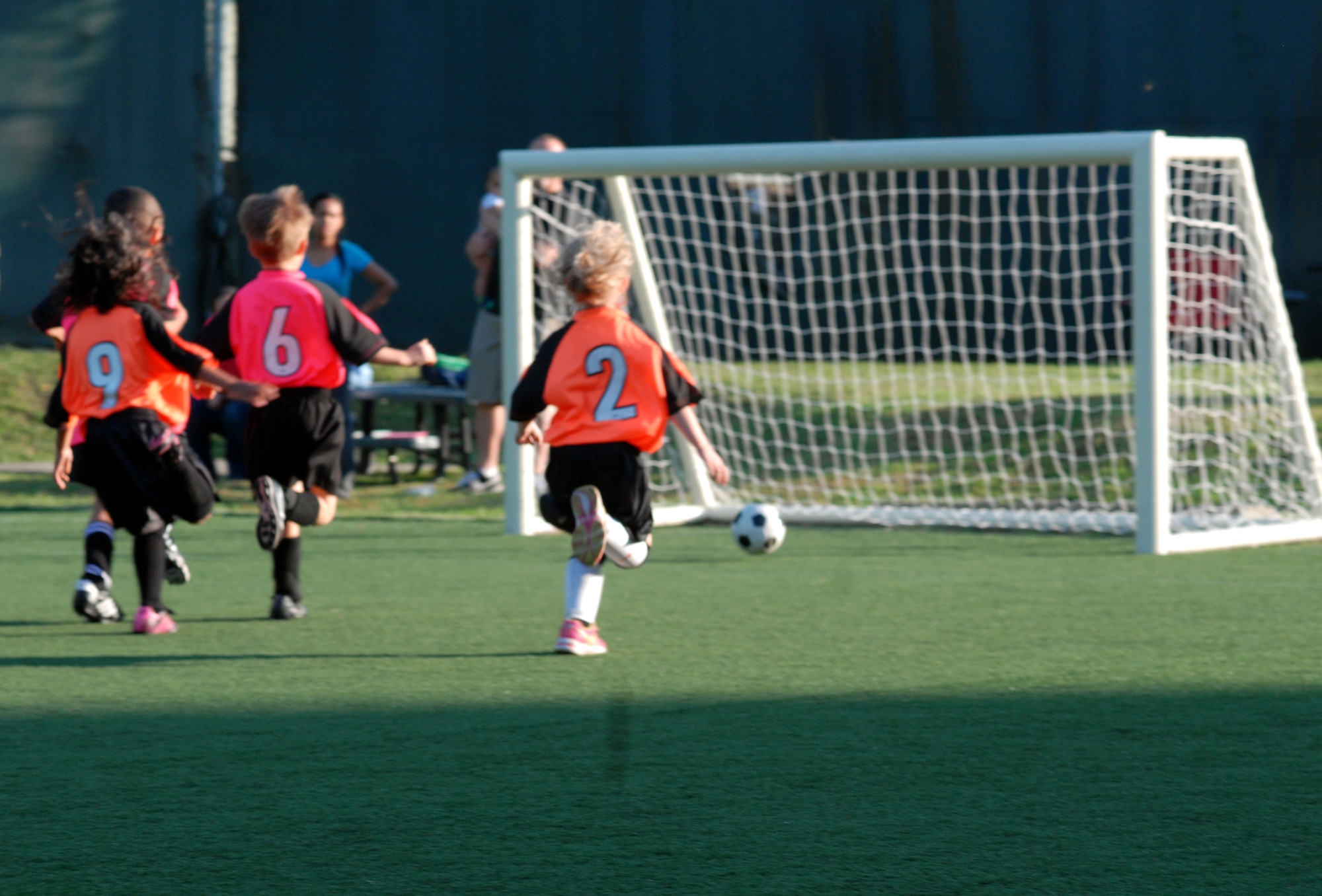 Youth Soccer players from the age 5-6 division run after a ball during a fast break play at Osan Air Base, Republic of Korea Sept. 26, 2013. The players represented the Dragons (orange) and the Crushers (pink). Youth sports are made possible by dedicated volunteer coaches from the base community. If interested in volunteering for seasonal youth sports, contact the director of youth sports by emailing matthew.sharman@us.af.mil. (U.S. Air Force photo/1st Lt. Kay M. Nissen)
