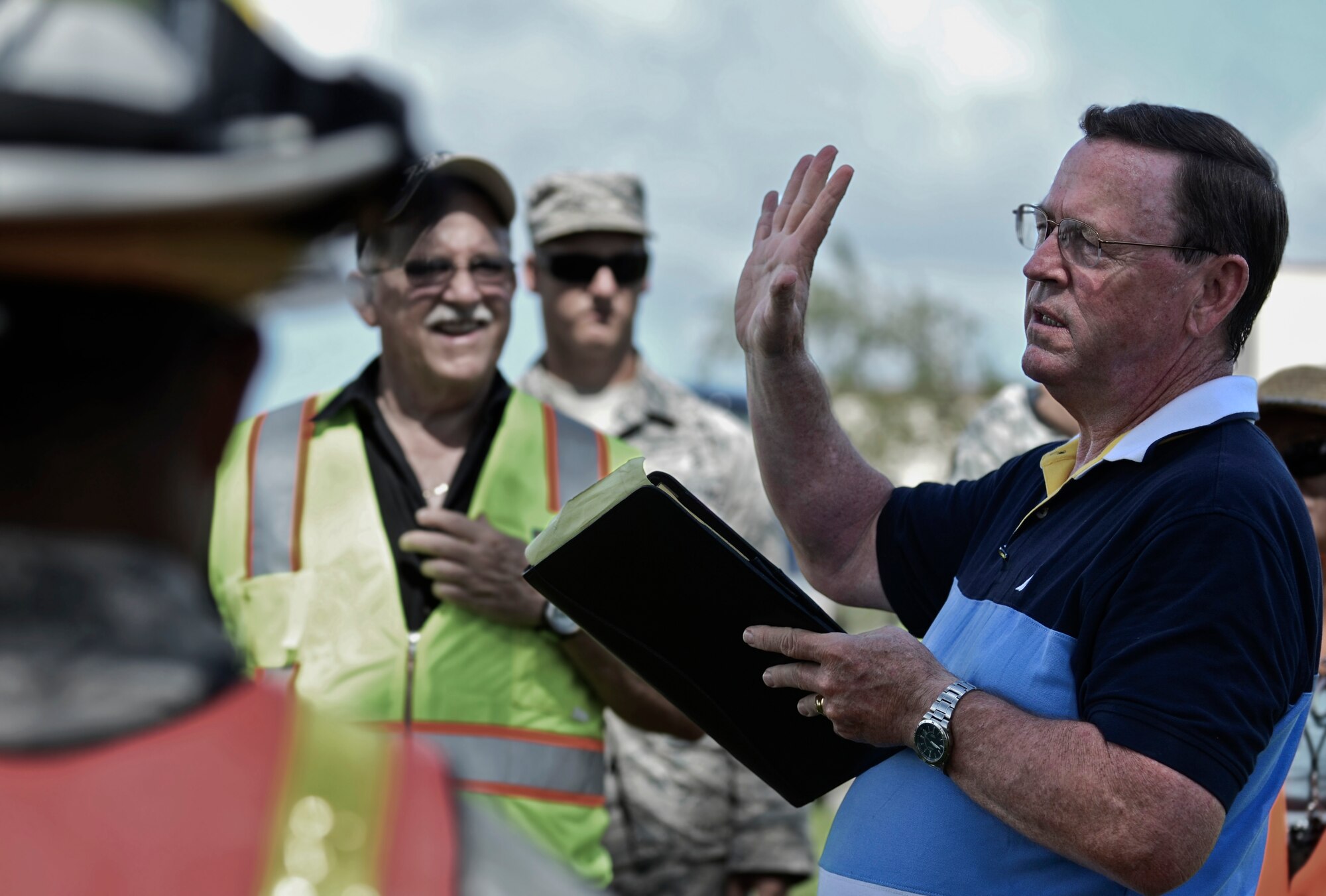 Michael Donohoe, ¬¬ Defense Logistics Agency preparedness and planning head contractor, discuss Team Andersen’s performance during the annual multi-agency fuel spill response training event Sept. 26, 2013, at the 36th Logistics Squadron Fuels Management Flight compound on Andersen Air Force Base, Guam. The training was conducted to comply with the provisions of the Oil Pollution Act of 1990, which states parties responsible for a vessel or facility from which oil or fuel is discharged and poses a substantial threat of a spill must have a plan to prevent spills that may occur and a detailed containment and cleanup plan. (U.S. Air Force photo by Senior Airman Marianique Santos/Released) 