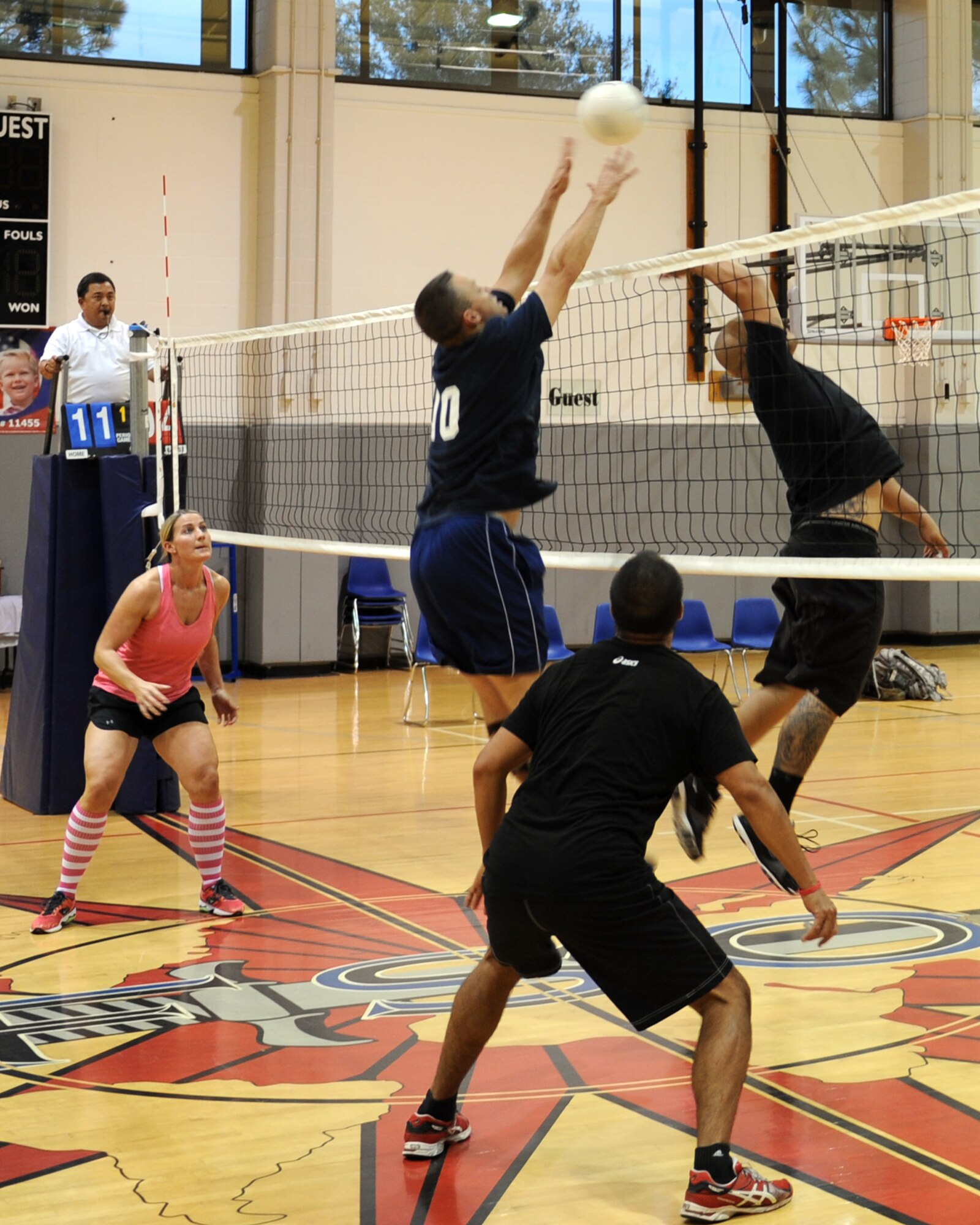 The 19th Special Operations Squadron volleyball team attempts to block a shot during the Hurlburt Field Intramural Volleyball Tournament Sept. 20, 2013, at Hurlburt Field, Fla. The team defeated the 801st Special Operations Aircraft Maintenance Squadron 25-23, 23-25 and 15-12 during the final matchup of the weeklong tournament. (U.S. Air Force photo/ Senior Airman Kentavist P. Brackin)
