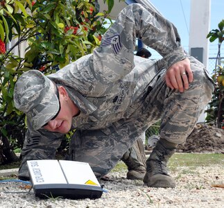 U.S. Air Force Staff Sgt. William Lane inspects a Broadband Global Area Network (BGAN) connection during a disaster response exercise in Belize, Sept. 26, 2013.  Lane serves as part of Joint Task Force-Bravo's Central America Survey and Assessment Team, and set up the team's tactical communication for the exercise.  (U.S. Air Force photo by Capt. Zach Anderson)