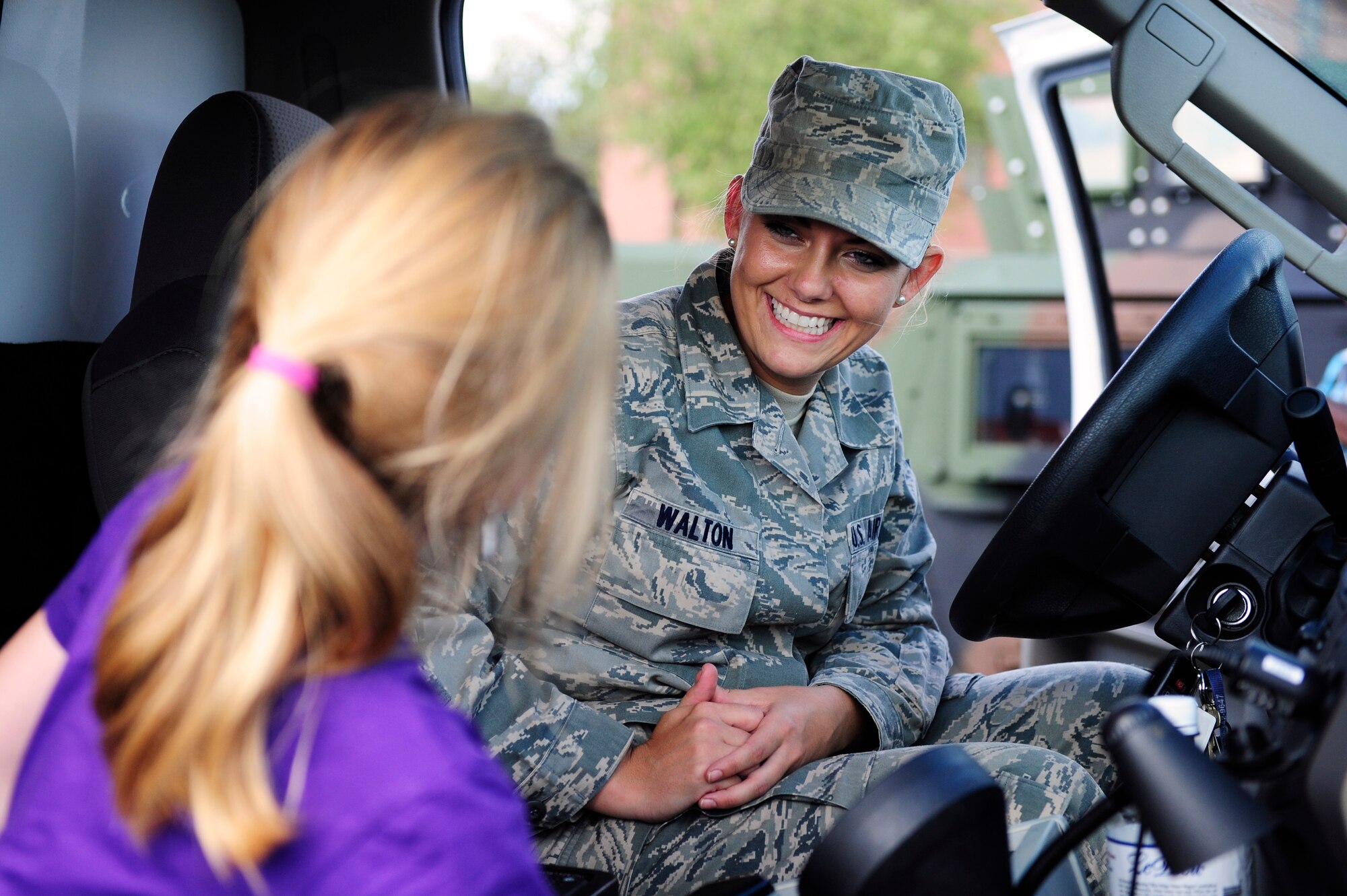 Senior Airman Georgina Walton, 20th Medical Group medical technician, shows children what her job entails and lets them use the ambulance siren during Operation Take Flight at Shaw Air Force Base, S.C., Sept. 26, 2013. Operation Take Flight is a deployment-simulation event that showcased various gear, weapons, vehicles and jobs in a fun manner for children. It was held to give children an idea of what the Air Force does, and what their parents go through when deploying. (U.S. Air Force photo by Airman 1st Class Daniel Blackwell/Released)