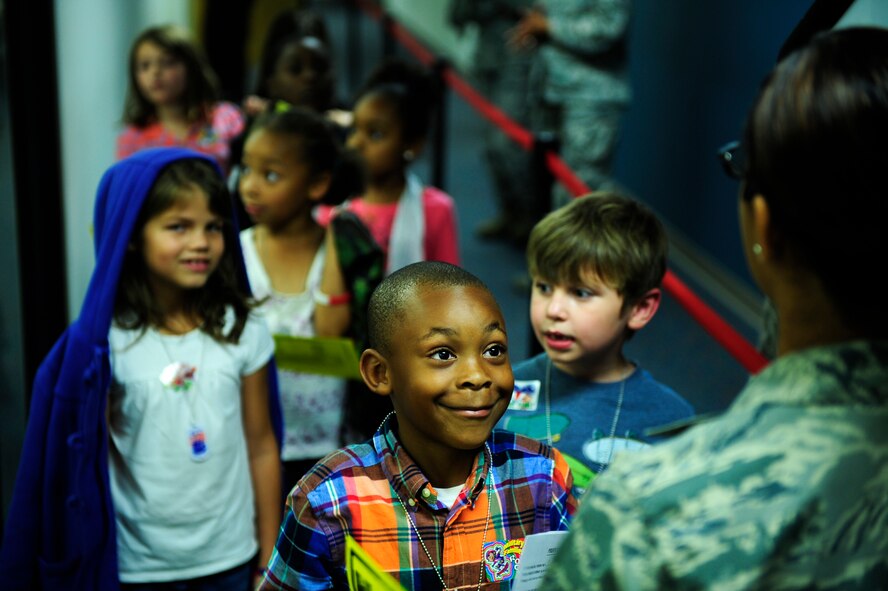 Children line up in the hallway of the deployment processing center as they “process the line” during Operation Take Flight at Shaw Air Force Base, S.C., Sept. 26, 2013. The deployment-simulation event was held to educate and orient children on what their parents experience when they deploy, while also showcasing various gear, weapons, vehicles and jobs in a fun manner for children. (U.S. Air Force photo by Airman 1st Class Daniel Blackwell/Released)
