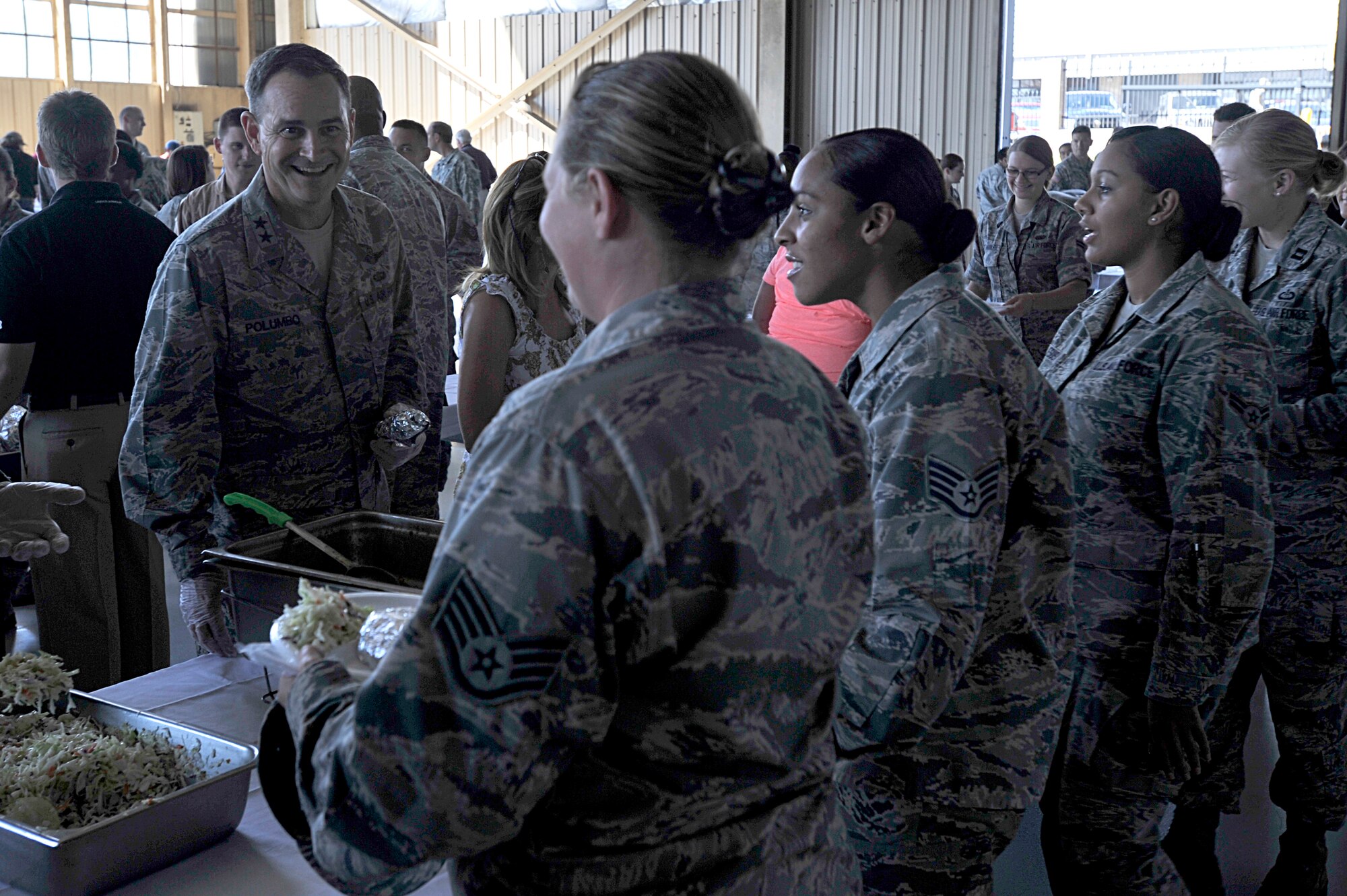 U.S. Air Force Maj. Gen. Jake Polumbo, 9th Air Force commander, serves food to Airmen during a military appreciation picnic, Shaw Air Force Base, S.C., Sept. 27, 2013. Team Shaw participated in a Comprehensive Airman Fitness day which was followed with a picnic provided by the Sumter community. (U.S. Air Force photo by Airman 1st Class Jensen Stidham/Released)