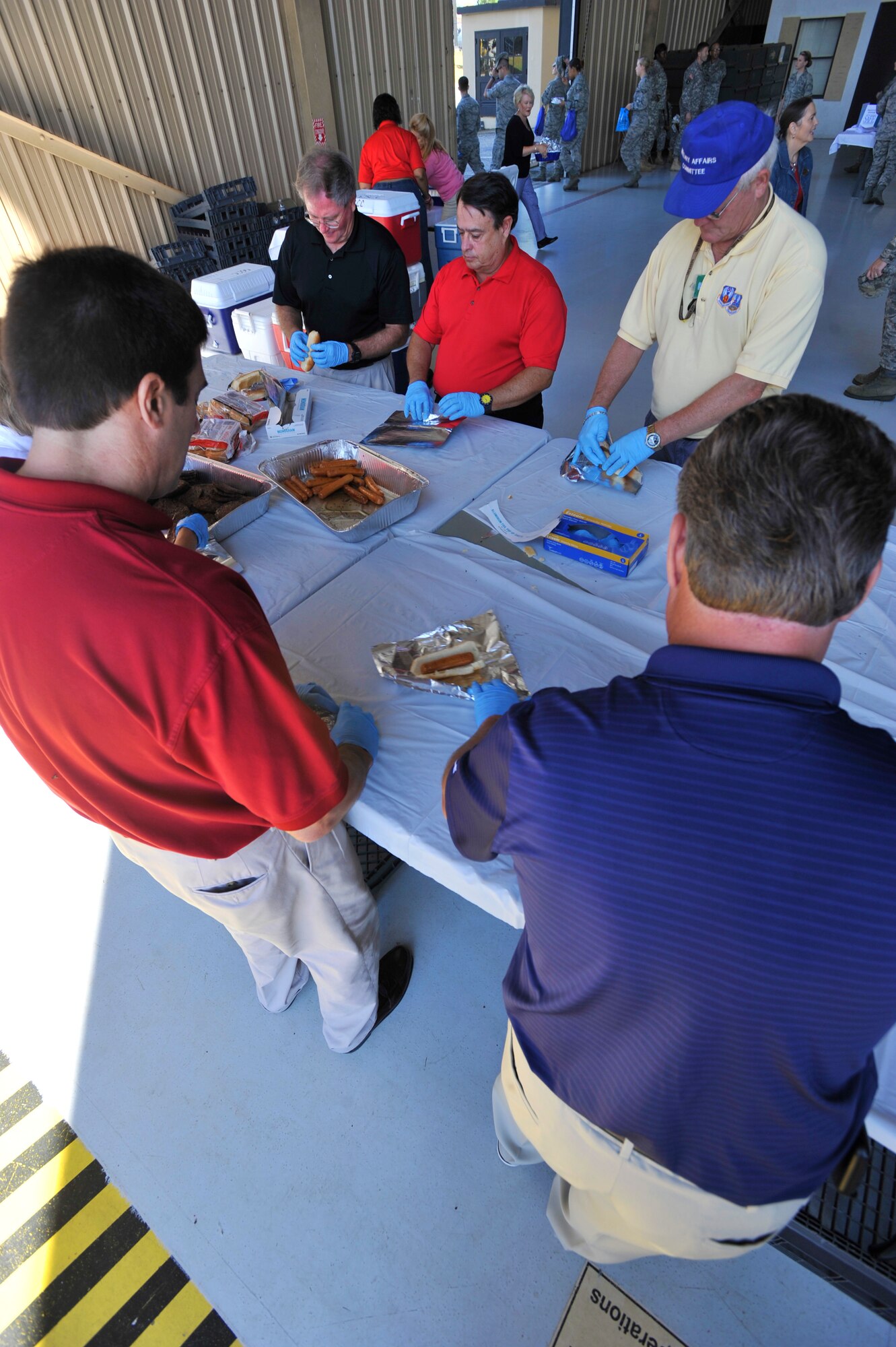 Sumter community volunteers prepare food for a military appreciation picnic, Shaw Air Force Base, S.C., Sept. 27, 2013. Team Shaw participated in a Comprehensive Airman Fitness day which was followed with a picnic provided by the Sumter community. (U.S. Air Force photo by Airman 1st Class Jensen Stidham/Released)