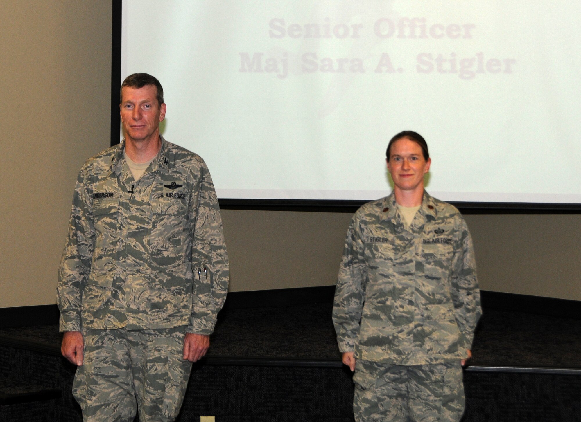 Maj. Sara Stigler, right, was the winner of the wing level Lance P. Sijan Leadership Award at the 188th Fighter Wing in the senior officer category. Col. Mark W. Anderson, 188th Fighter Wing commander, recognized Stigler for this accolade at a recent commander’s call Sept. 7, 2013. (U.S. Air National Guard photo by Airman 1st Class Cody Martin/188th Fighter Wing Public Affairs)