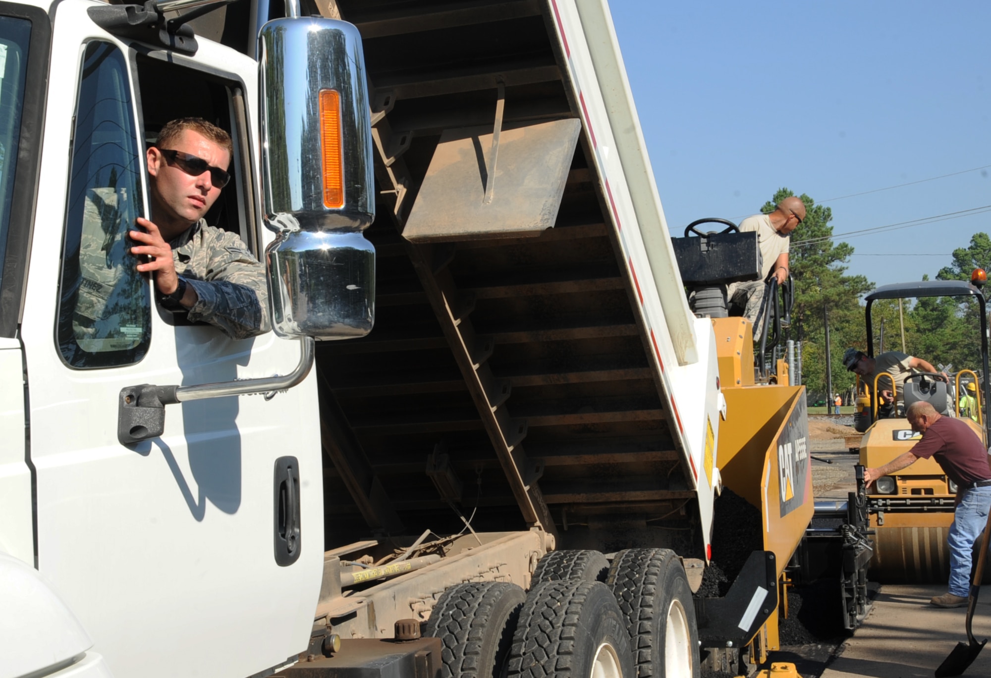 Airman 1st Class Jon Martinez, 2nd Civil Engineer Squadron paving and equipment apprentice, waits for further instruction during road construction at the Bodcau gate on Barksdale Air Force Base, La., Sept. 27, 2013.The gate construction is estimated to be completed on Oct. 15, 2013. (U.S. Air Force photo/Senior Airman Sean Martin)
