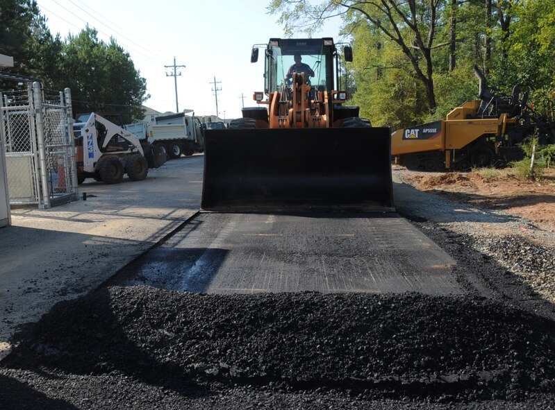 Kevin Mycroft, 2nd Civil Engineer Squadron paving and equipment operator, prepares to pick up asphalt during construction at the Bodcau gate on Barksdale Air Force Base, La., Sept. 27, 2013. This project, along with parish and railroad efforts, will enable 2,000 East Reservation housing residents to have access to Haughton schools, cutting commute time in half. (U.S. Air Force photo/Senior Airman Sean Martin)