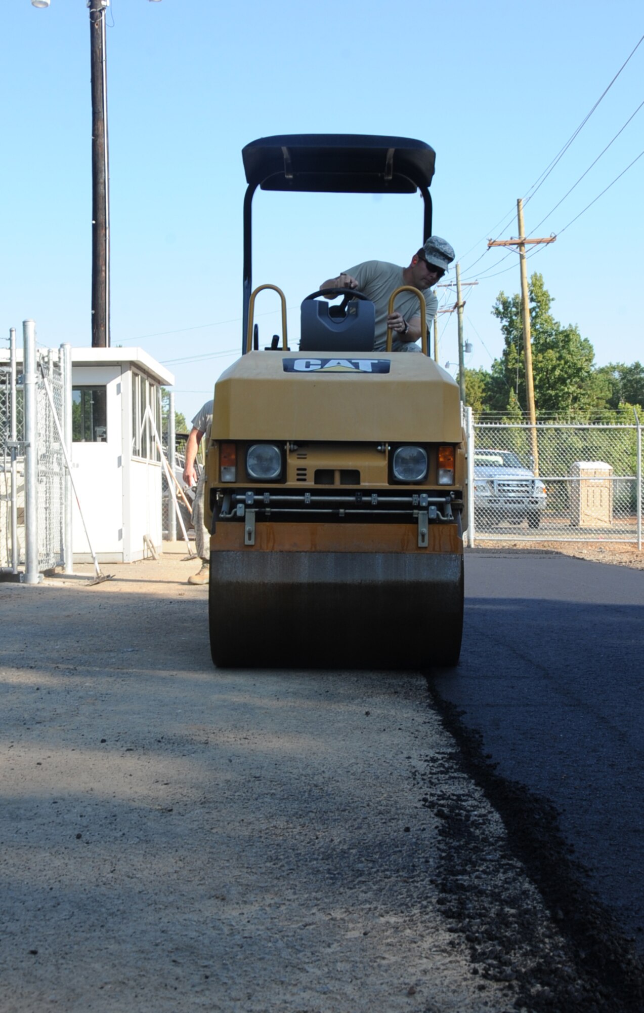 Tech. Sgt. Floyd Butkiewicz, 2nd Civil Engineer Squadron paving and equipment assistant NCO in-charge, compacts a road during construction at the Bodcau gate on Barksdale Air Force Base, La., Sept. 27, 2013. Pavement and equipment Airmen are responsible for maintaining the airfield, roadways, perimeter fence and any other surface on the base. (U.S. Air Force photo/Senior Airman Sean Martin)
