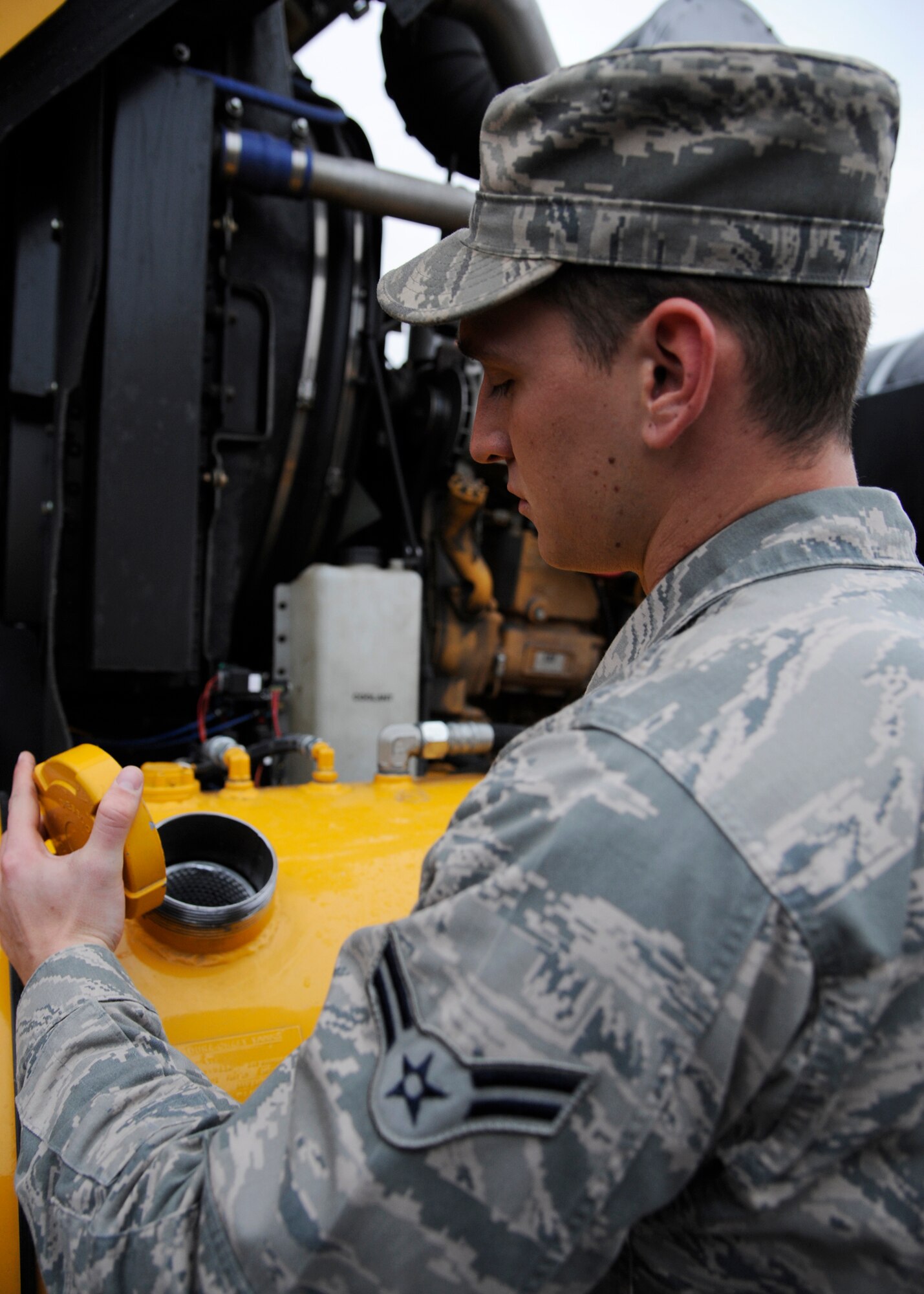 Airman 1st Class David Cline, 354th Civil Engineer Squadron heavy equipment operator, inspects the oil levels of a snow plow Sept. 26, 2013, Eielson Air Force Base, Alaska. Each operator inspects their vehicle prior to driving to confirm it is safe to operate. (U.S. Air Force photo by Senior Airman Ashley Nicole Taylor/Released)