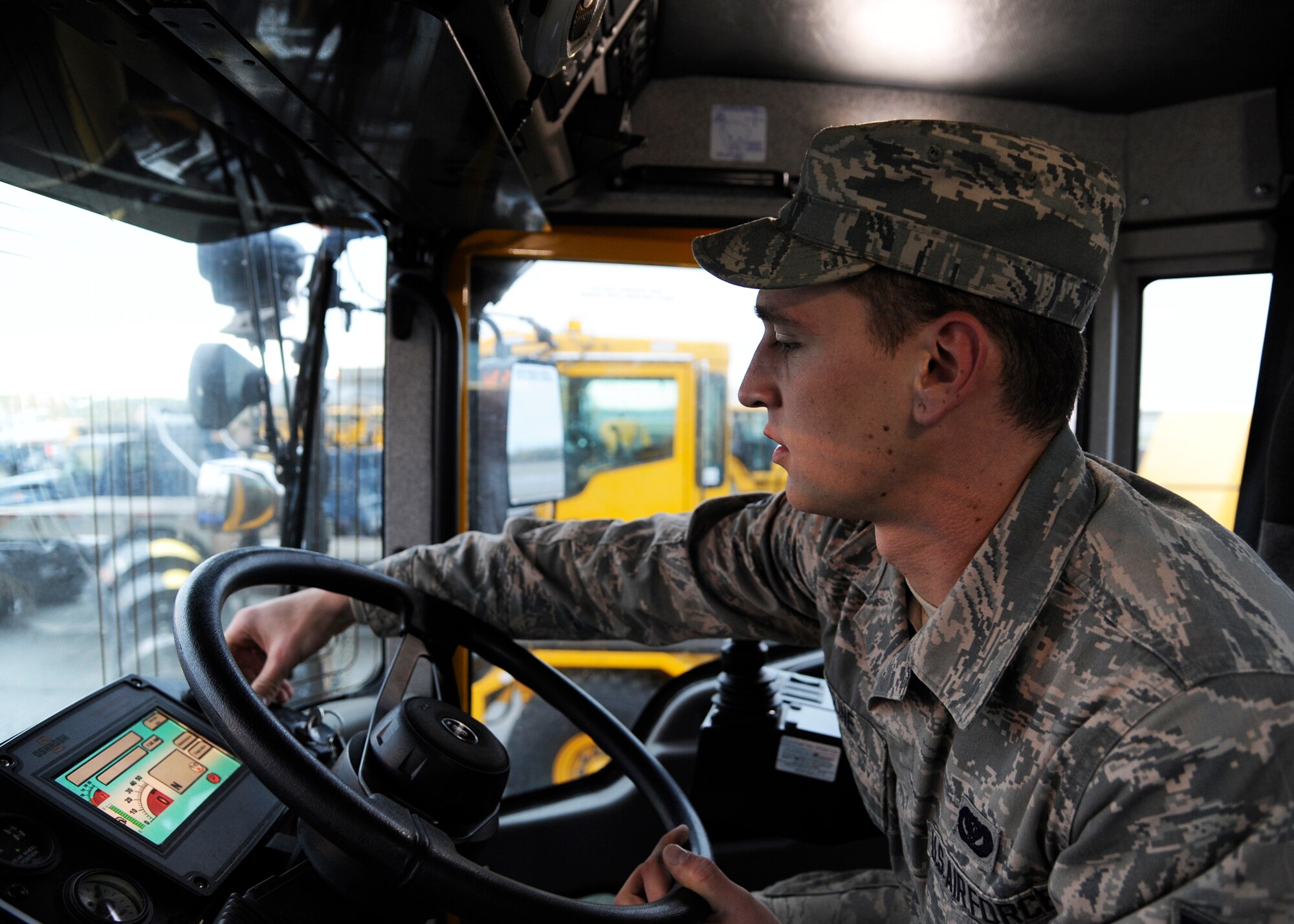Airman 1st Class David Cline, 354th Civil Engineer Squadron heavy equipment operator, familiarizes himself with the controls of a snow plow Sept. 26, 2013, Eielson Air Force Base, Alaska. Eielson’s Snow Barn team of more than 55 Airmen ensures roads and sidewalks are safe during the harsh Alaskan winter. (U.S. Air Force photo by Senior Airman Ashley Nicole Taylor/Released)