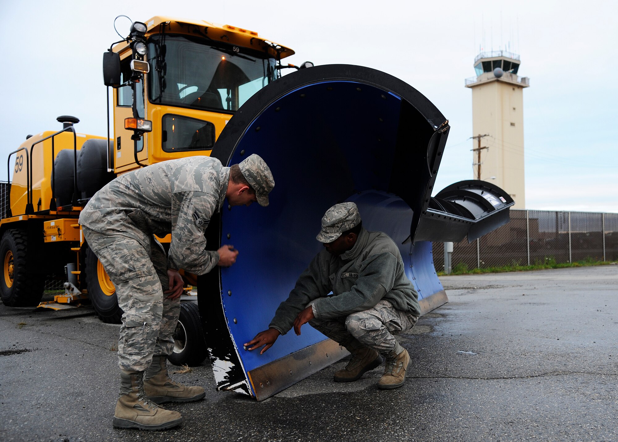 Airmen 1st Class David Cline and Trai Mobley, 354th Civil Engineer Squadron heavy equipment operators, inspect the front of a snow plow Sept. 26, 2013, Eielson Air Force Base, Alaska. During the winter, Eielson’s Snow Barn is responsible for keeping 838 acres cleared of snow. (U.S. Air Force photo by Senior Airman Ashley Nicole Taylor/Released)