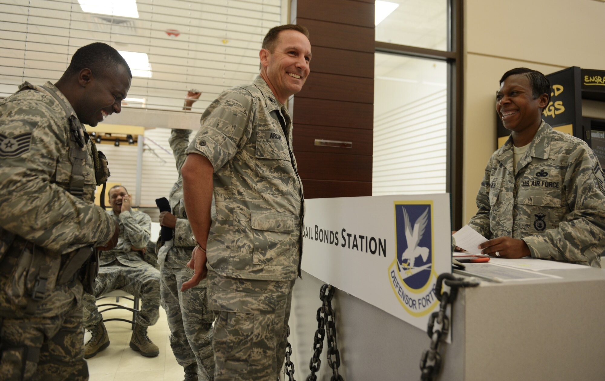 U.S. Air Force Tech. Sgt. Antwan Sibley, 20th Security Forces Squardon patrolman, prepares to uncuff Col. Scott Arcuri, 20th Mission Support Group commander, during the SFS Jail and Bail fundraiser, Shaw Air Force Base, S.C., Sept. 26, 2013. 20th SFS held a base wide Jail and Bail fundraiser for the Defender's Association, during which they handcuffed 57 Airmen and Soldiers and raised $1,464. (U.S. Air Force photo by Senior Airman Tabatha Zarrella/Released)
