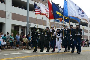 Service members in a joint color guard carry the colors and military flags in the Neptune Festival Grand Parade in Virginia Beach, Va., Sept. 28, 2013. The parade stretched across more than 16 blocks along Atlantic Avenue and featured local high school bands and charity organizations. (U.S. Air Force photo by Airman 1st Class Victoria H. Taylor/ Released)