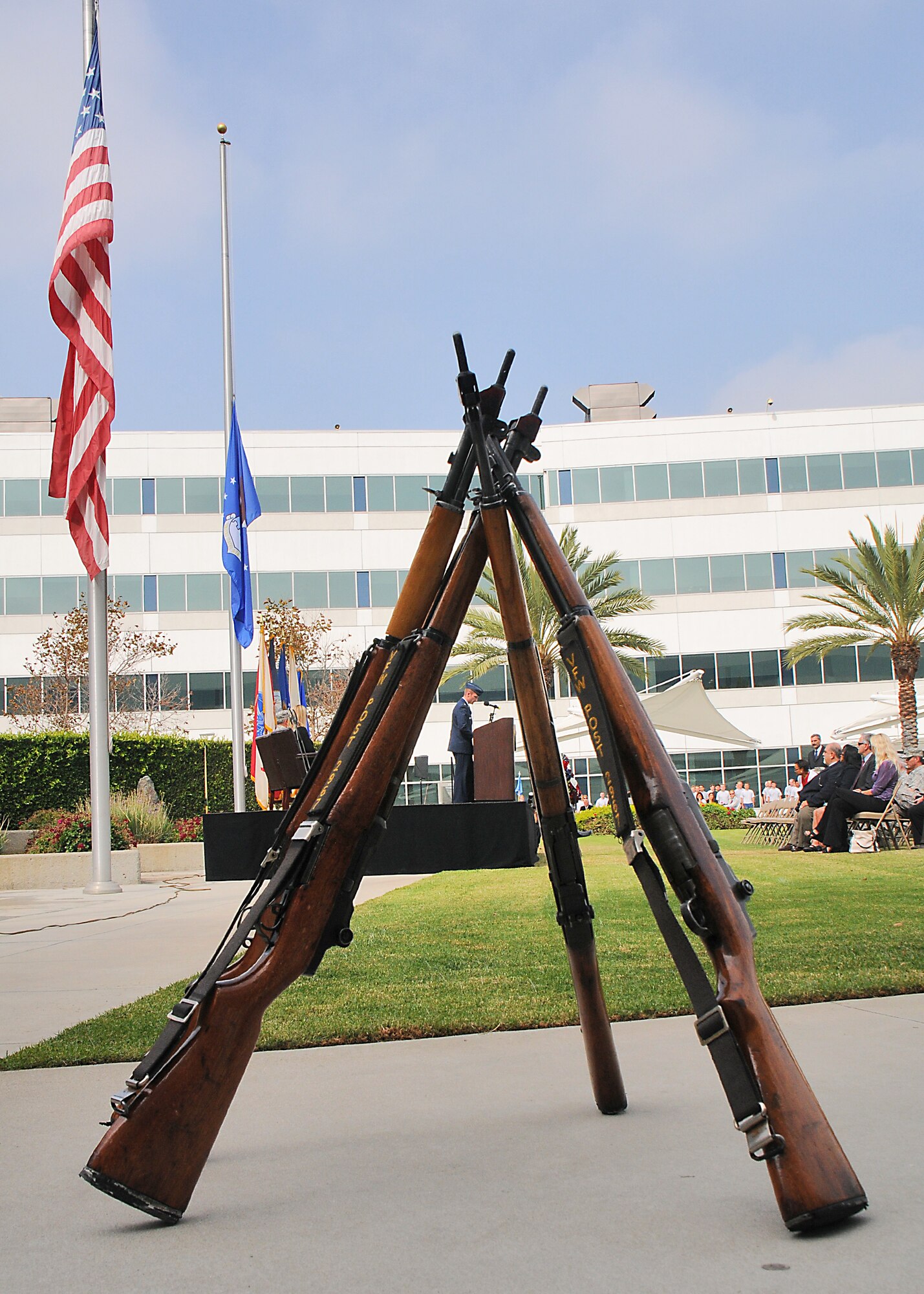 Rifles are stacked in the Schriever Courtyard during the wreath laying ceremony. (Photo by Joe Juarez)