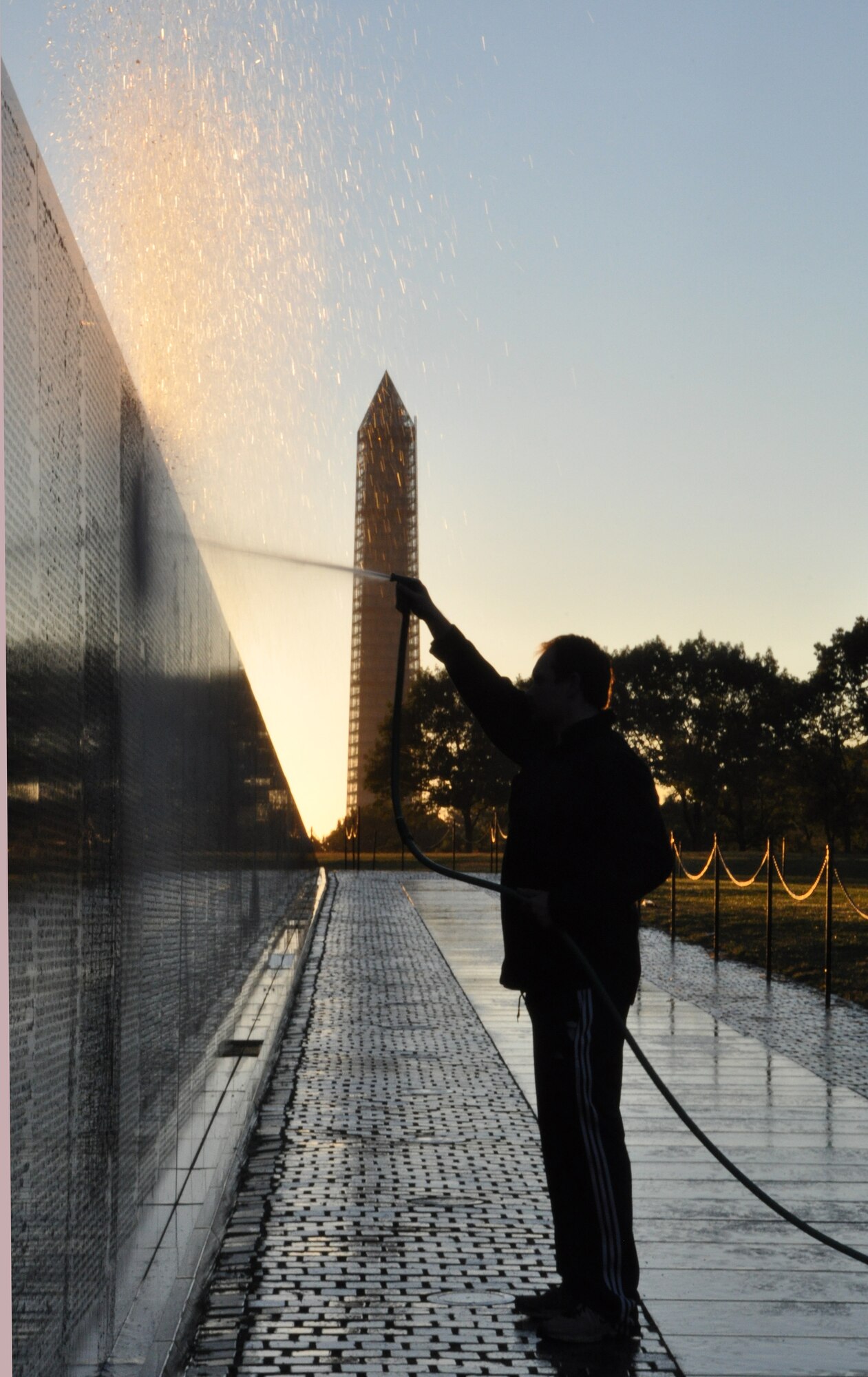 An Airmen from the 459th Air Refueling Wing at Joint Base Andrews, Md., sprays water on the wall at the Vietnam Memorial, Washington D.C., September 28, 2013. The wall washing is a volunteer effort to keep national monuments clean and maintained. (U.S. Air Force photo/ Staff Sgt. Katie Spencer)
