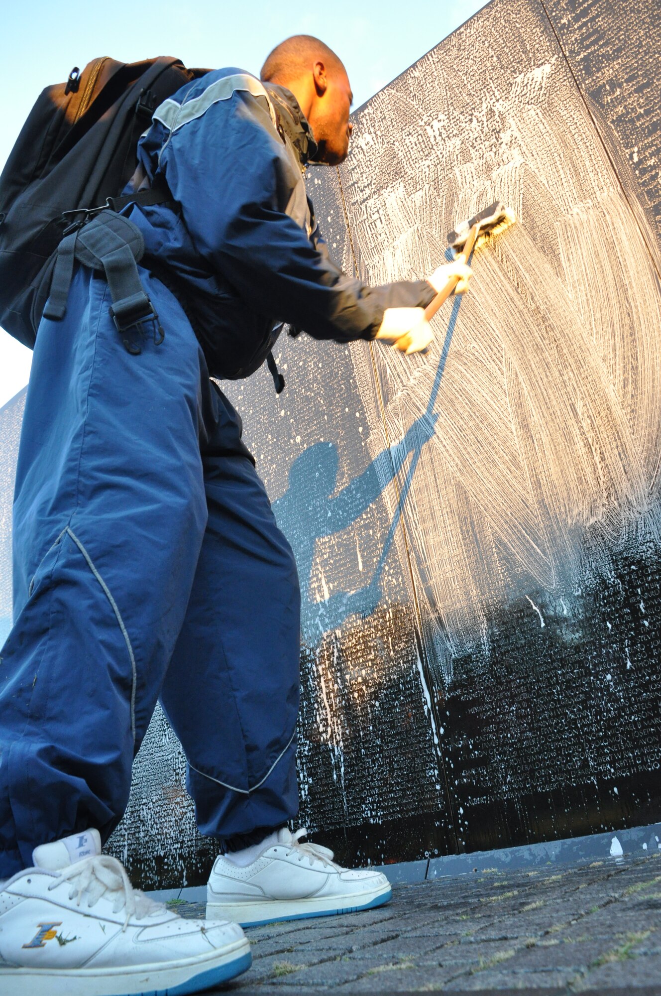 An Airmen from the 459th Air Refueling Wing at Joint Base Andrews, Md., washes the wall at the Vietnam Memorial, Washington D.C., September 28, 2013. The wall washing is a volunteer effort to keep national monuments clean and maintained. (U.S. Air Force photo/ Staff Sgt. Katie Spencer)