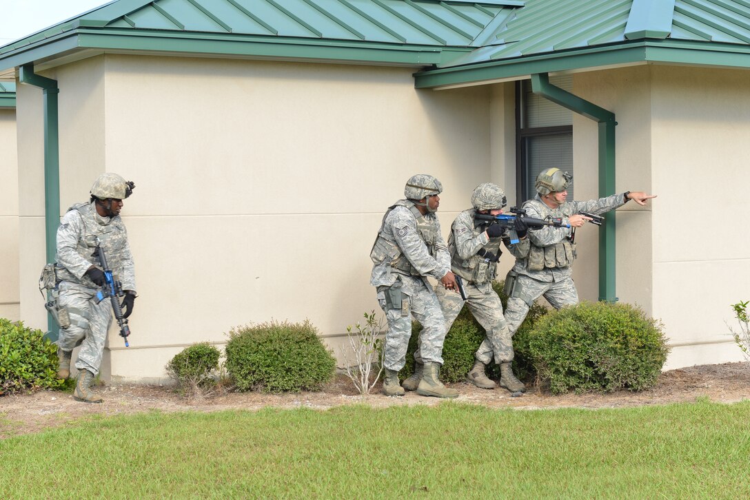 U.S. Air Force Airmen from the 165th Airlift Wing, Georgia Air National Guard respond to an active shooter during an exercise created to test first responders, Sept. 12, 2013 at Savannah Air National Guard Base in Garden City, Ga. 165th Security Forces contained the simulated shooter prior to the arrival of Emergency Medical Service personnel. (National Guard photo by Tech. Sgt. Charles Delano/released)