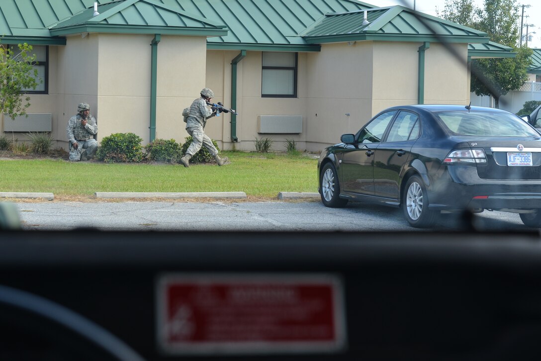 U.S. Air Force Airmen from the 165th Airlift Wing, Georgia Air National Guard respond to an active shooter during an exercise created to test first responders, Sept. 12, 2013 at Savannah Air National Guard Base in Garden City, Ga. 165th Security Forces contained the simulated shooter prior to the arrival of Emergency Medical Service personnel. (National Guard photo by Tech. Sgt. Charles Delano/released)