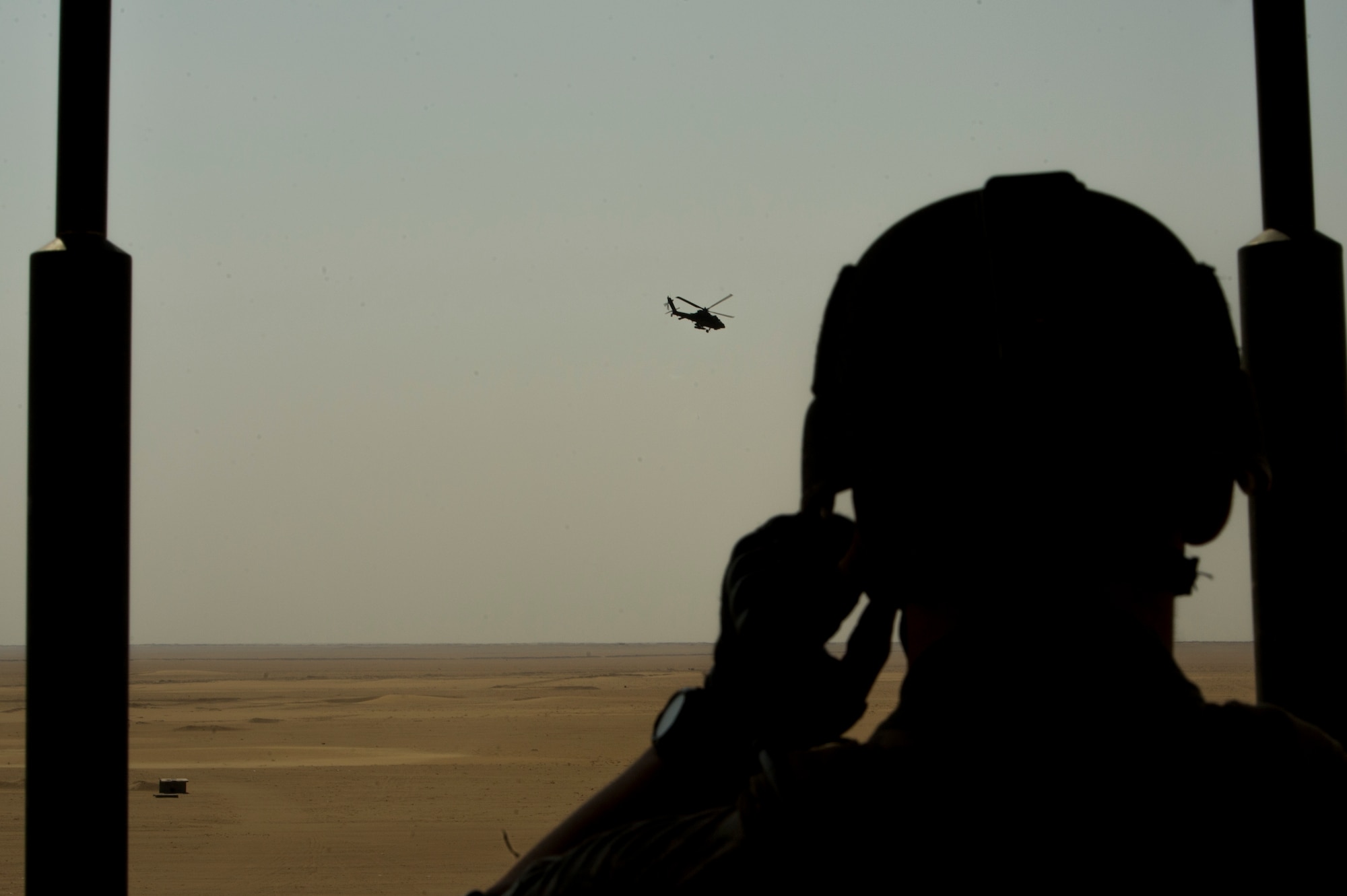 U.S. Air Force Staff Sgt. Nick Heffron, 82nd Expeditionary Air Support Operations Squadron joint terminal attack controller, talks to Army AH-64 Apache helicopter pilots during a Joint Air Attack Team live-fire exercise at an undisclosed location in Southwest Asia, Sept. 18, 2013. A JAAT is where both fixed wing and rotary wing assets all fire in to the same area. The 82nd EASOS is an Air Force unit that provides air-to-ground and weather expertise to the U.S. Army Central Task Force. (U.S. Air Force photo by Staff Sgt. Stephany Richards)

