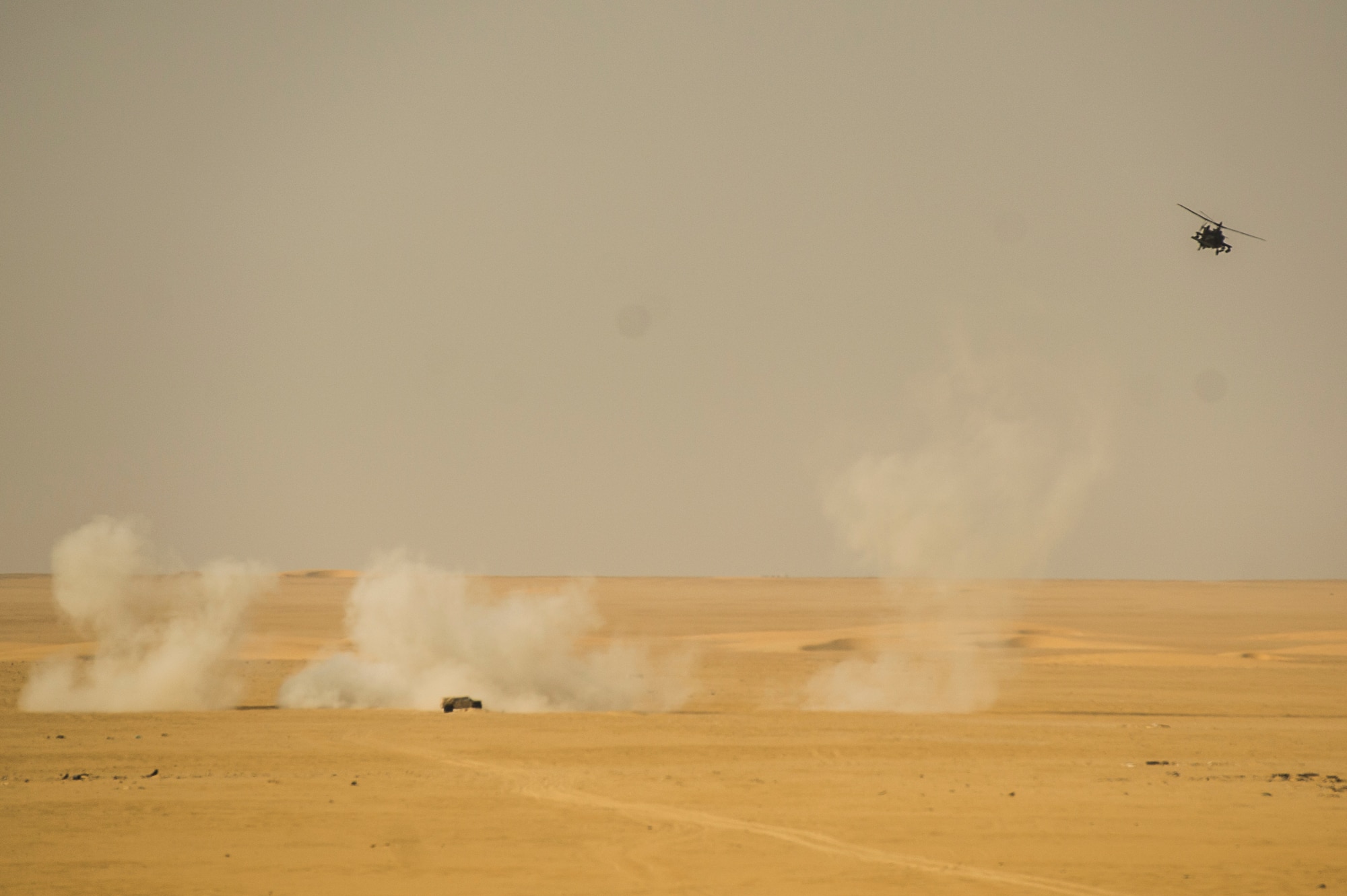 A U.S Army AH-64 Apache helicopter with the 36th Aviation Brigade participates in a Joint Air Attack Team live-fire exercise at an undisclosed location in Southwest Asia, Sept. 18, 2013. A JAAT is where both fixed wing and rotary wing assets all fire in to the same area. The 82nd EASOS is an Air Force unit that provides air-to-ground and weather expertise to the U.S. Army Central Task Force. (U.S. Air Force photo by Staff Sgt. Stephany Richards)
