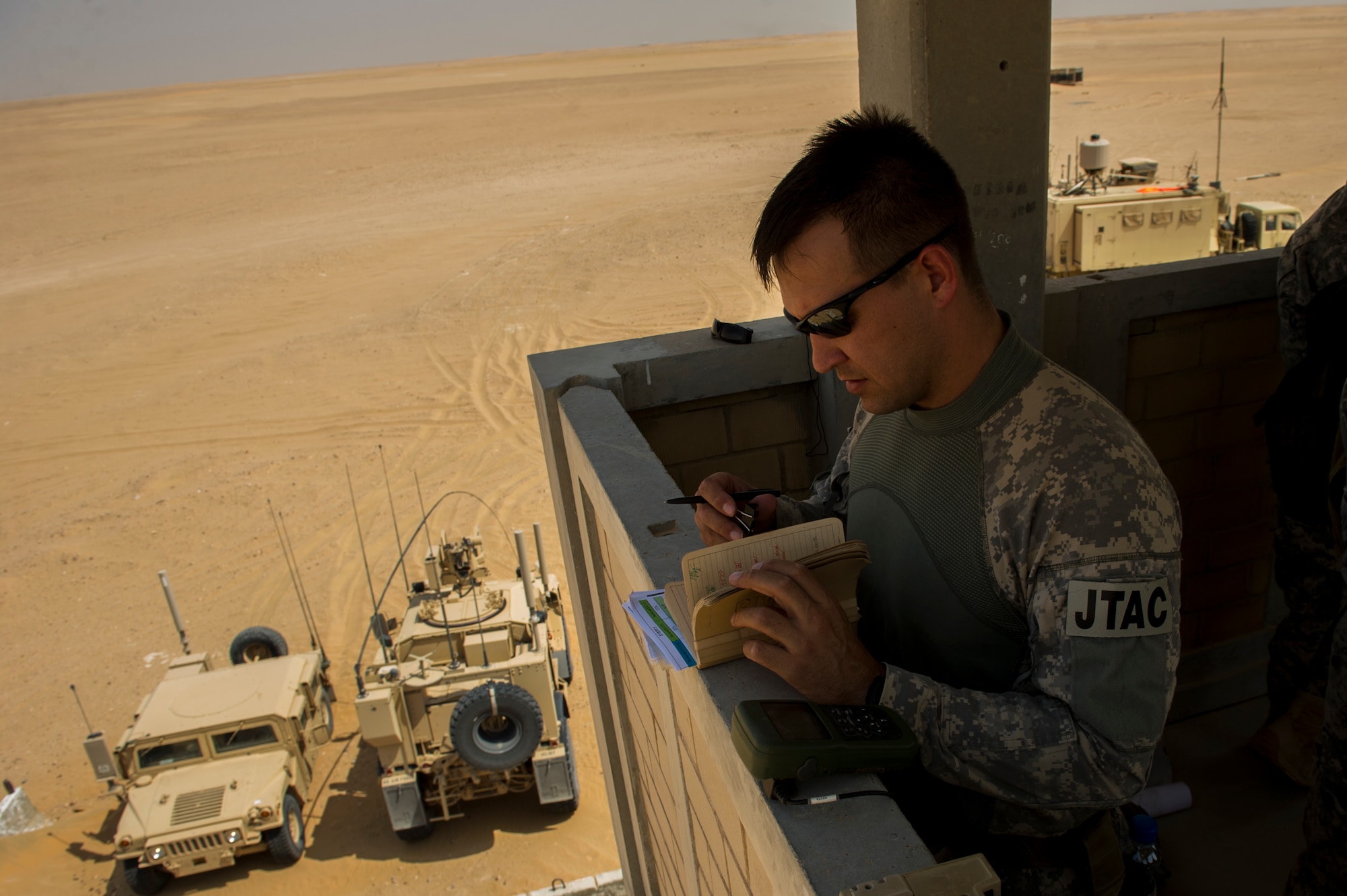 U.S. Air Force Staff Sgt. Jedidiah Pearson, 82nd Expeditionary Air Support Operations Squadron joint terminal attack controller, prepares for a Joint Air Attack Team live-fire exercise at an undisclosed location in Southwest Asia, Sept. 18, 2013. A JAAT is where both fixed wing and rotary wing assets all fire in to the same area. The 82nd EASOS is an Air Force unit that provides air-to-ground and weather expertise to the U.S. Army Central Task Force. (U.S. Air Force photo by Staff Sgt. Stephany Richards)