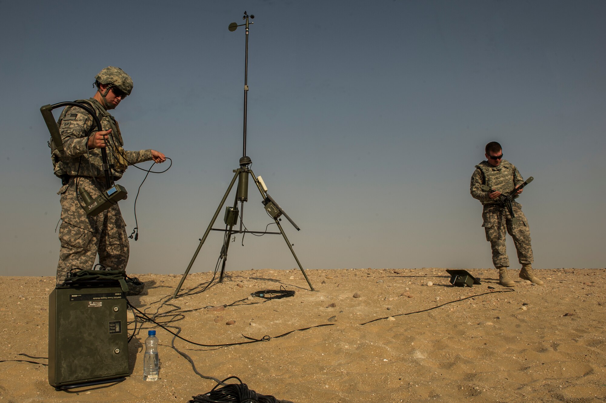 U.S. Air Force Tech. Sgt. Johnie Smith and Tech. Sgt. James Foutz, 82nd Expeditionary Air Support Operations Squadron combat weather, disassembles the mobile weather sensing equipment after a Joint Air Attack Team live-fire exercise at an undisclosed location in Southwest Asia, Sept. 18, 2013. "The equipment allows us to do our job in a tactical weather environment." (U.S. Air Force photo by Staff Sgt. Stephany Richards)