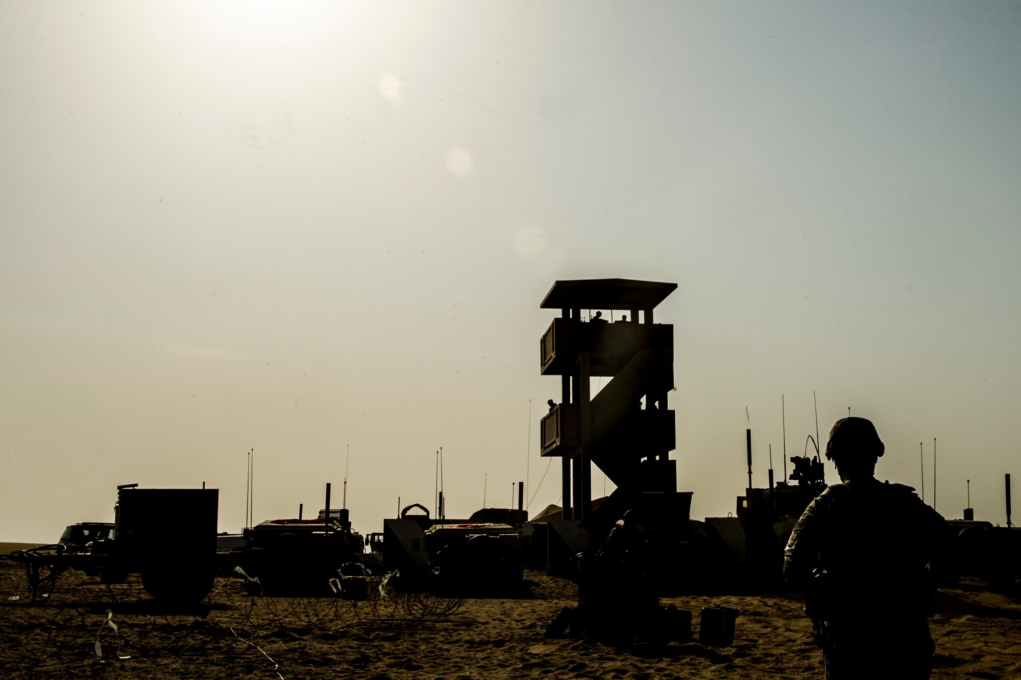 U.S. Air Force Tech. Sgt. Johnie Smith, 82nd Expeditionary Air Support Operations Squadron combat weather, walks to the control tower during a Joint Air Attack Team live-fire exercise at an undisclosed location in Southwest Asia, Sept. 18, 2013. A JAAT is where both fixed wing and rotary wing assets all fire in to the same area. The 82nd EASOS is an Air Force unit that provides air-to-ground and weather expertise to the U.S. Army Central Task Force. (U.S. Air Force photo by Staff Sgt. Stephany Richards)