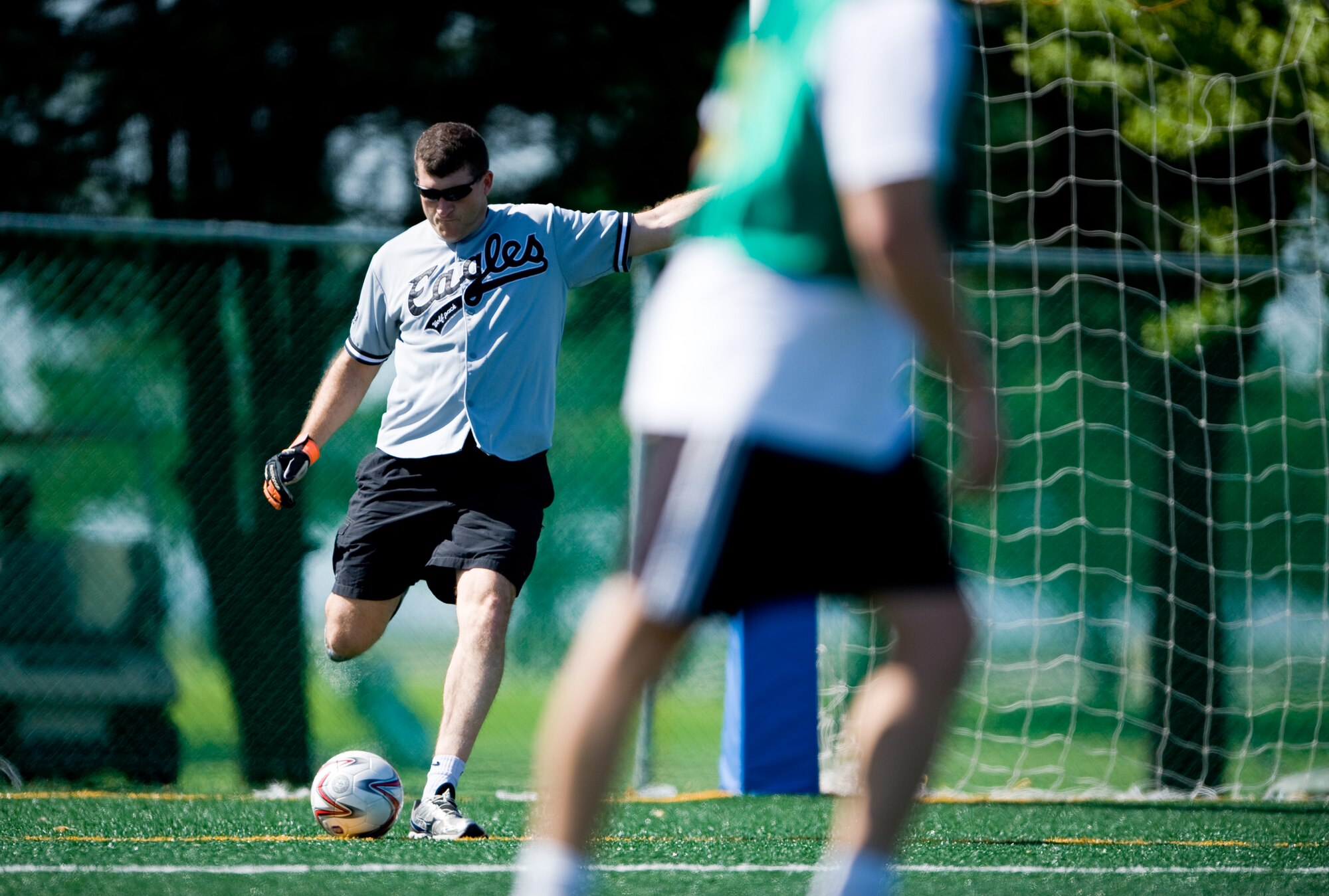 Col. S. Clinton Hinote, 8th Fighter Wing commander, kicks a ball back into play at Kunsan Air Base, Republic of Korea, Sept. 27, 2013. Hinote was competing in the 2013 Korean and American Friendship Day commander’s football game. (U.S. Air Force photo by Senior Airman Armando A. Schwier-Morales/ Released)