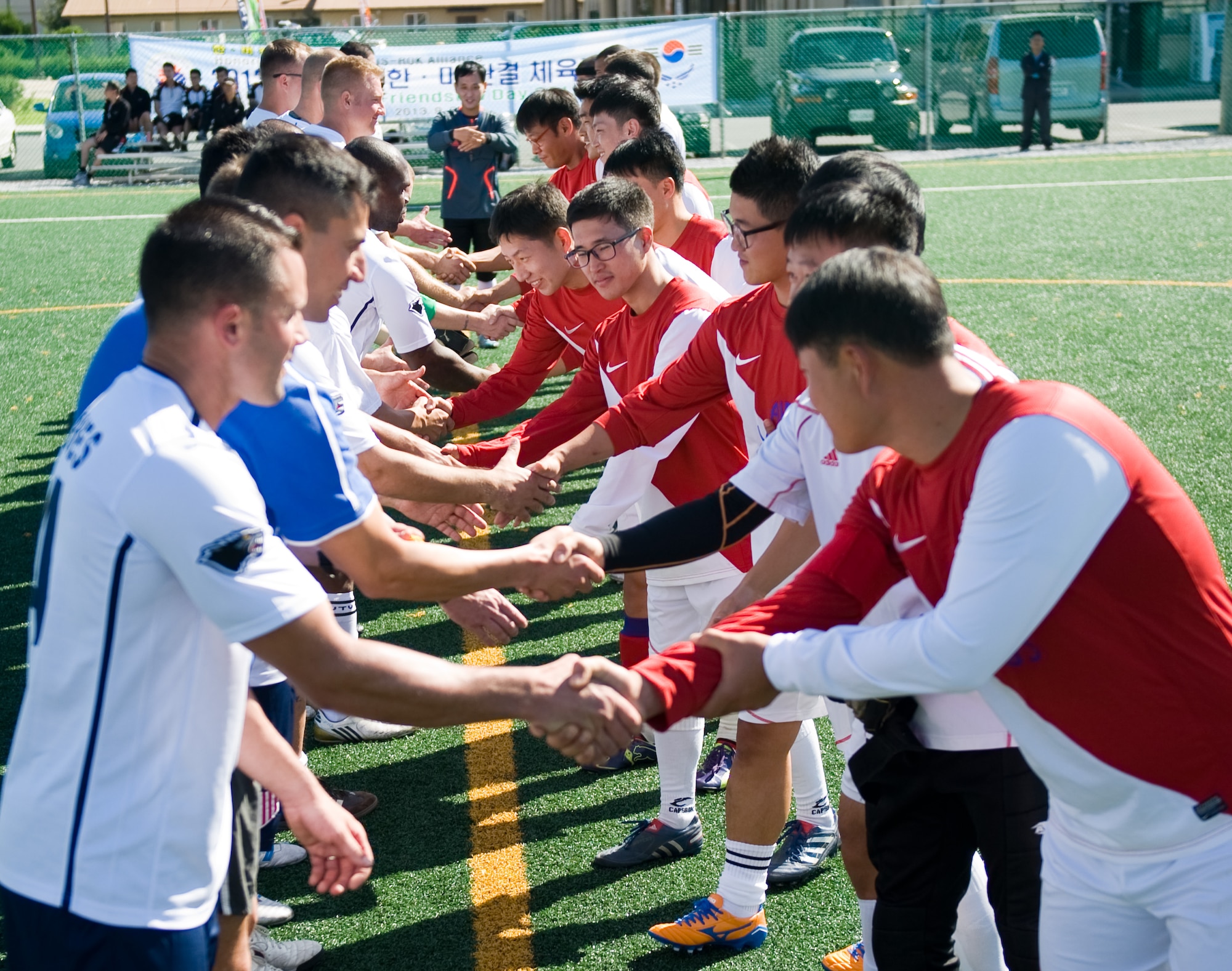 Prior to their game, the U.S. Air Force and Republic of Korea Air Force base soccer teams shake hands at Kunsan Air Base, Republic of Korea, Sept. 27, 2013. As part of the 2013 Korean and American Friendship Day, both teams had a friendly competition with the U.S. team winning the game 4 - 2. (U.S. Air Force photo by Senior Airman Armando A. Schwier-Morales/ Released)