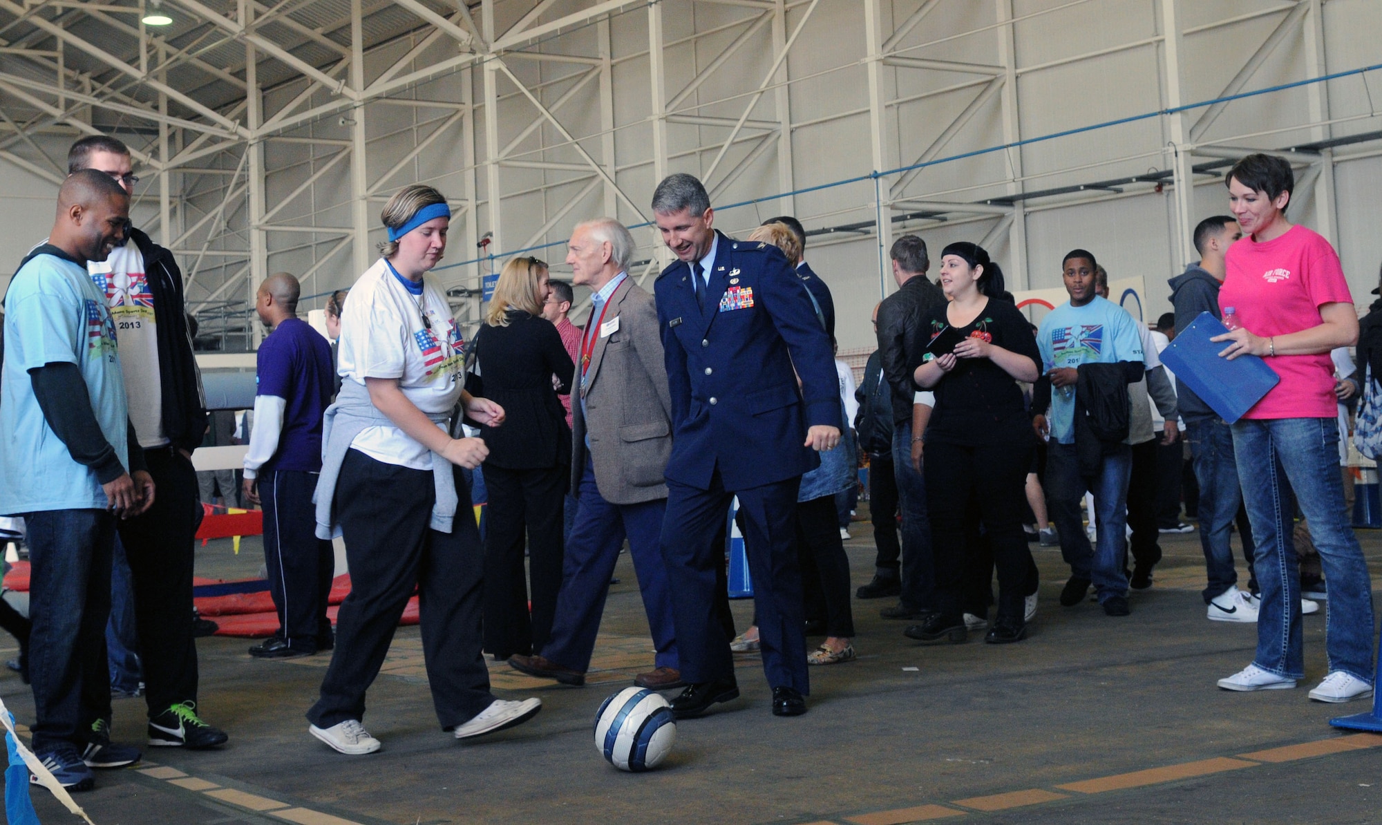 U.S. Air Force Col. Matthew Grant, U.S. Air Forces in Europe-UK director of legal services, plays soccer with athletes at Joan Mann Special Sports Day Sept. 28, 2013, on RAF Mildenhall, England. The sports day tradition began when Joan Mann, a Ministry of Defence employee who worked in the public affairs office on RAF Mildenhall, sought a way to bring the community together and work with special-needs citizens. (U.S. Air Force photo by Airman 1st Class Jonathan Light/Released)