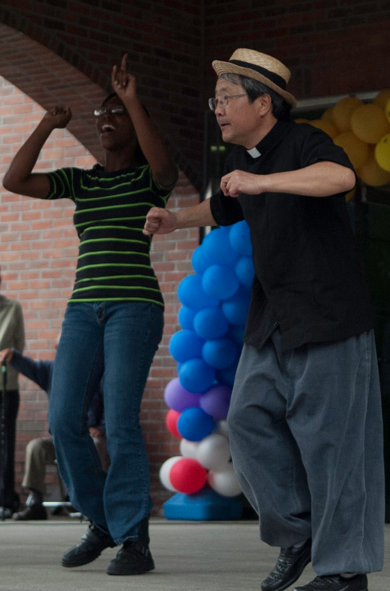 Ardella Lowary, left, learns a Korean dance with a local Jeonju Priest at the  Mount Saint Joseph Home for the Aged family day in Haewol-ri, Republic of Korea, Sept. 28, 2013. Airmen from the 8th Fighter Wing voluteered throughout the day visiting with residents and families at the retirement home. (U.S. Air Force photo by Tech. Sgt. Alex Griffin/Released)