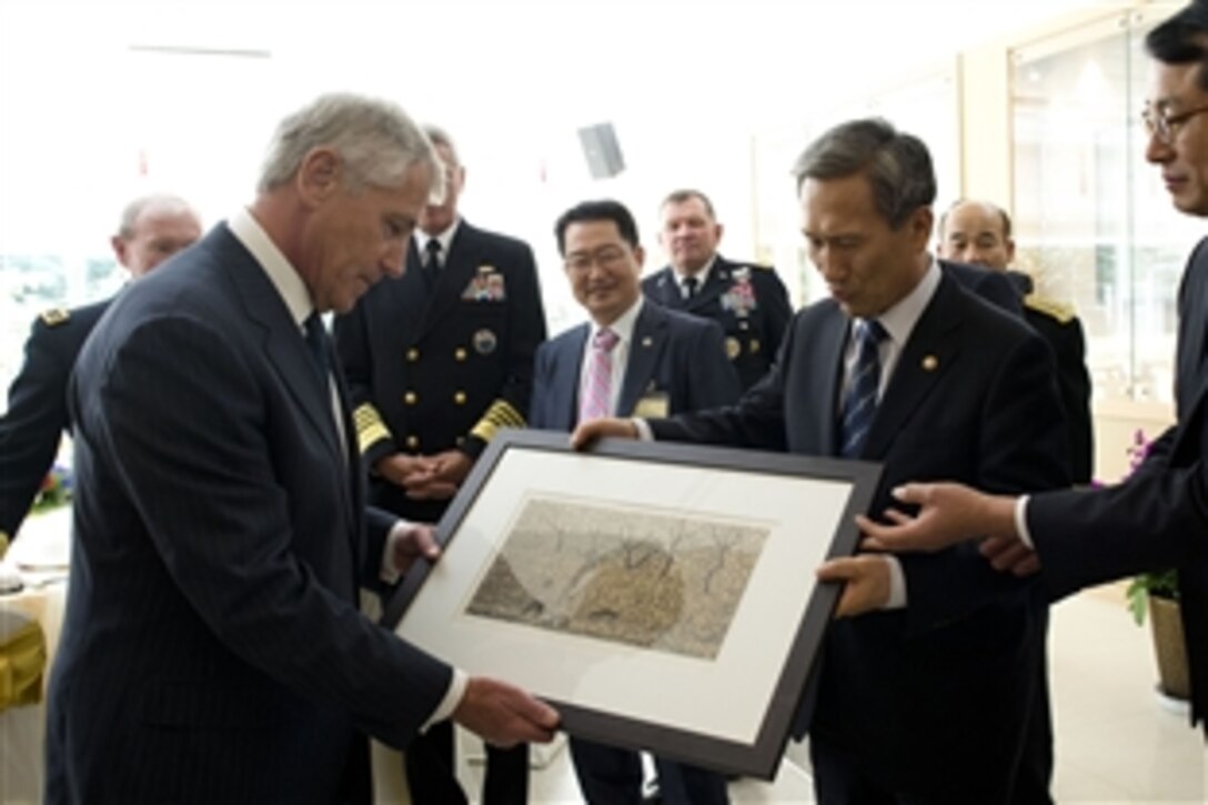 U.S. Defense Secretary Chuck Hagel, left, receives a painting from South Korean Defense Minister Kim Kwan-jin in Seoul, South Korea, Oct. 1, 2013. Hagel and U.S. Army Gen. Martin E. Dempsey, chairman of the Joint Chiefs of Staff, attended a military parade to commemorate the 60th anniversary of the U.S.-South Korean alliance. 